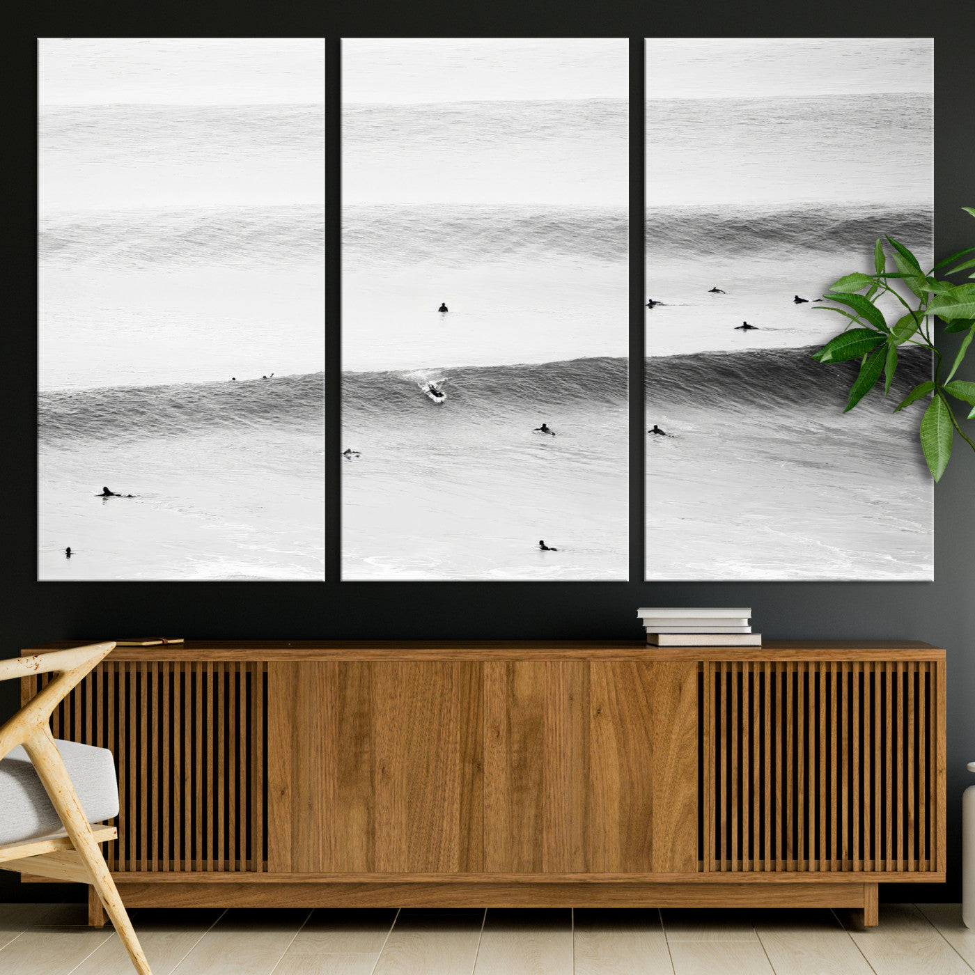 A monochrome photograph of swimmers gliding through gentle ocean waves, evoking a sense of calm and movement.