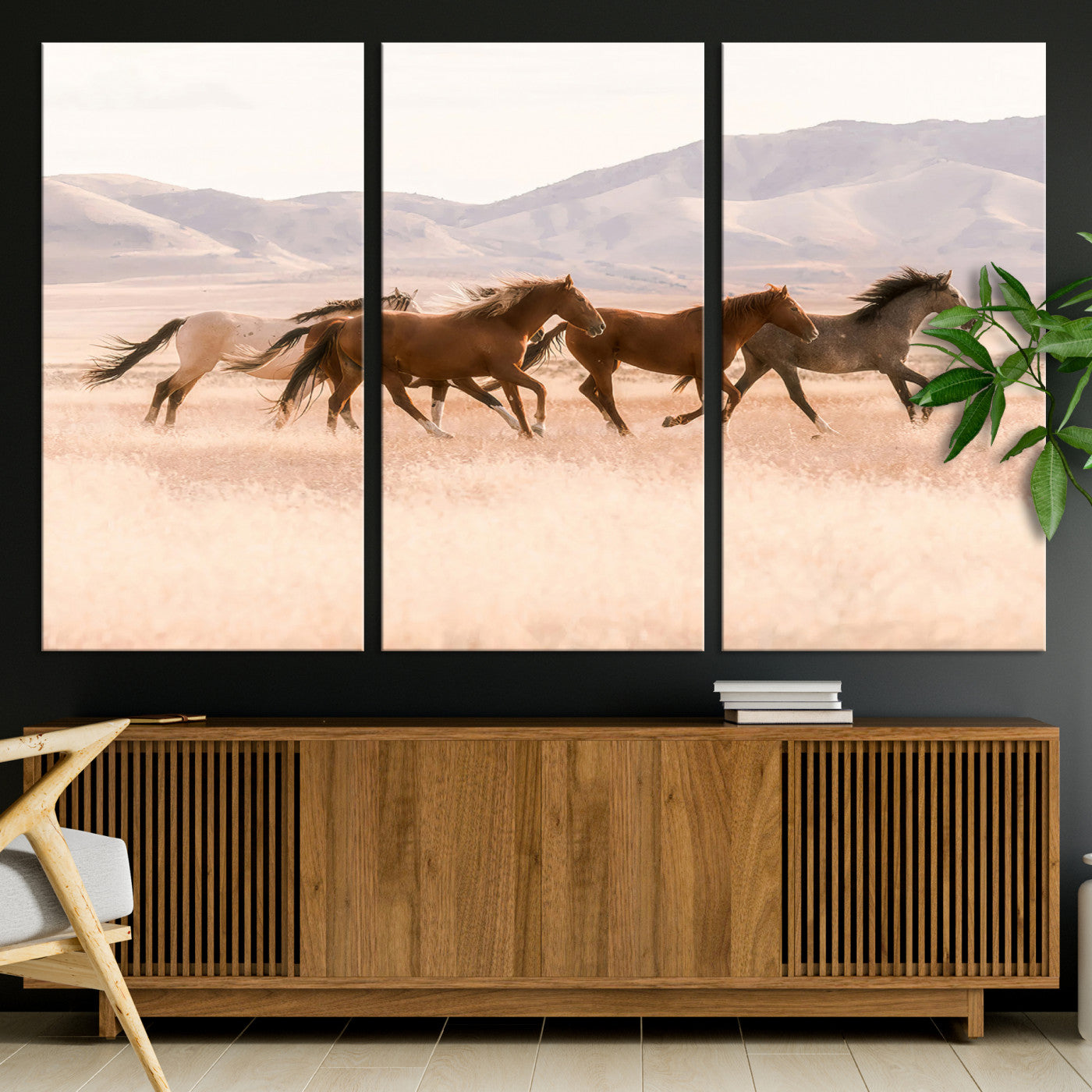 A herd of wild horses galloping through a sunlit desert plain with mountains in the background, perfect for rustic or western-themed wall decor.
