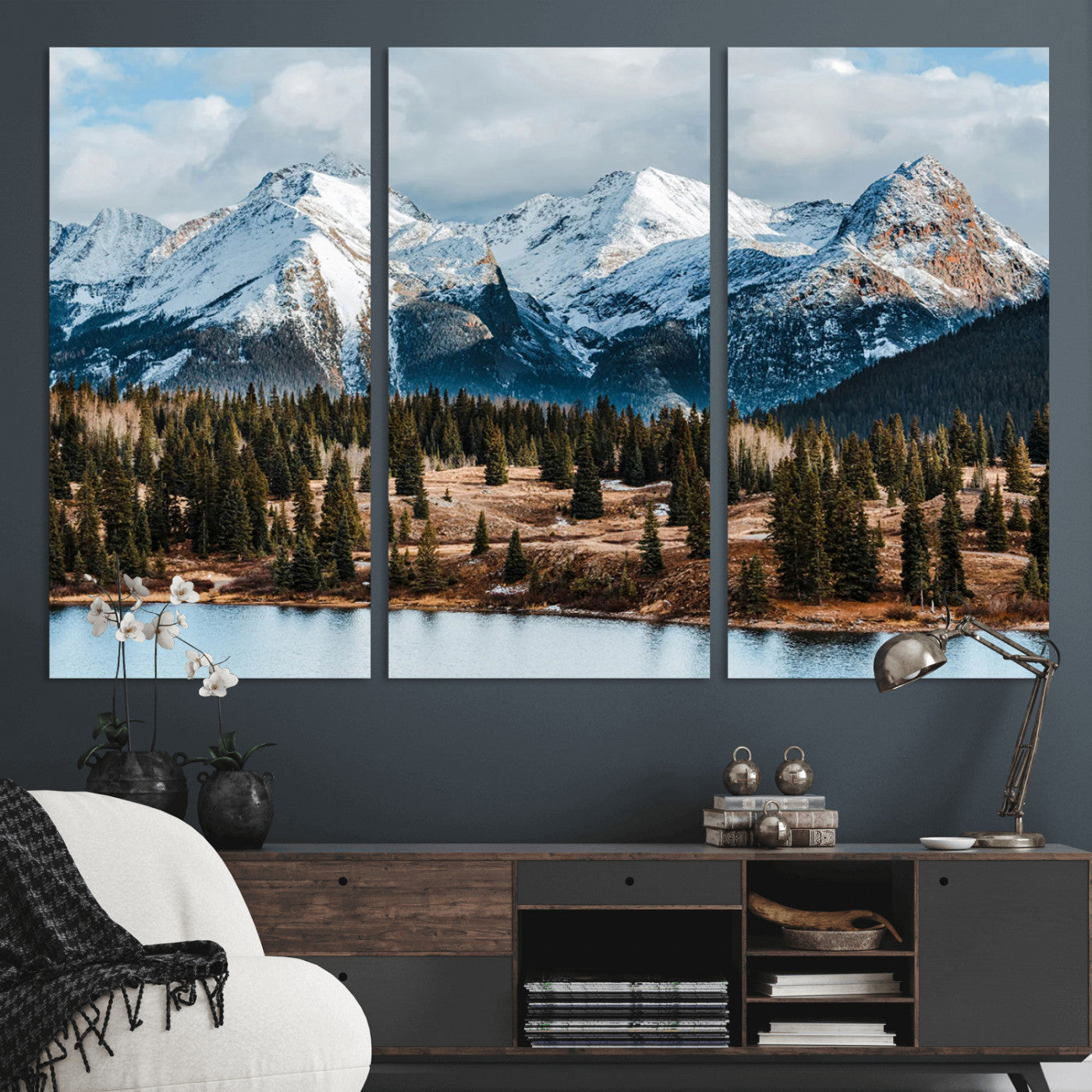 Framed canvas of snowy mountain peaks with pine forest and alpine lake, perfect for winter cabin or wilderness-inspired home decor.