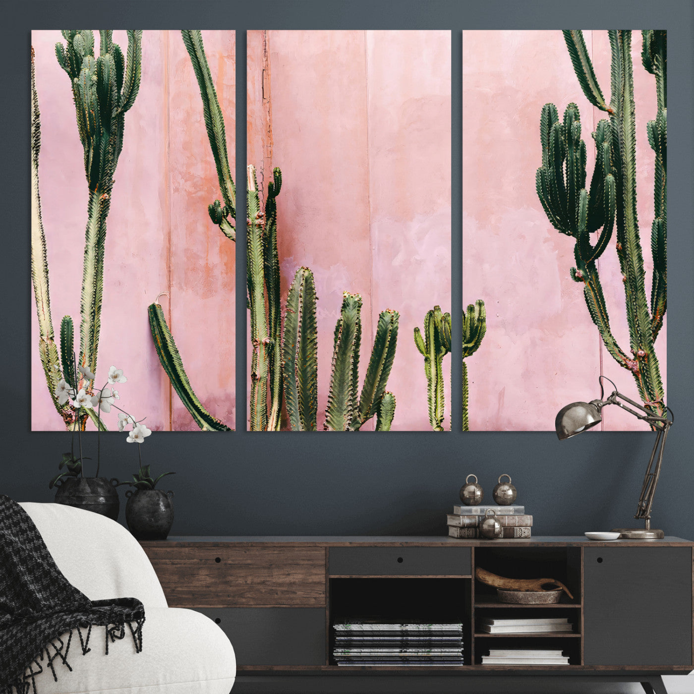 Framed canvas of tall green cacti against a soft pink wall, ideal for modern desert or colorful southwest-inspired home decor.