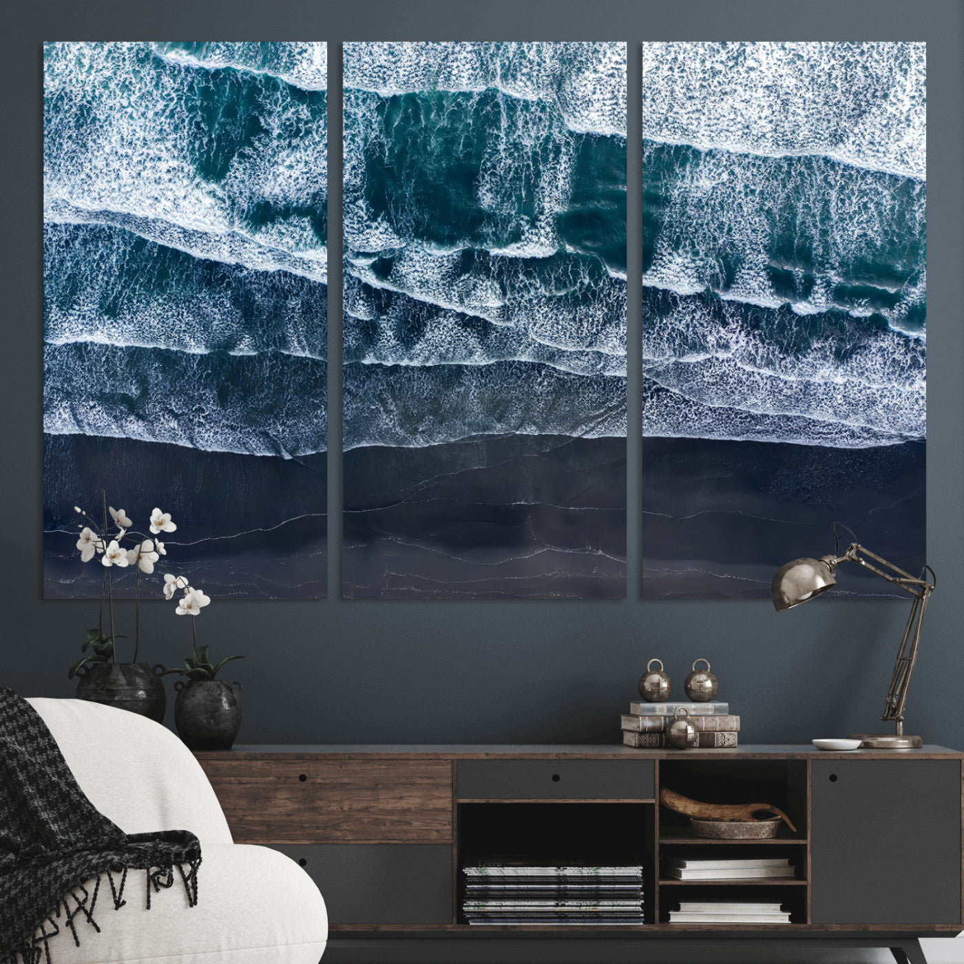 Canvas of aerial ocean waves crashing onto a black sand beach in moody tones, ideal for modern coastal or minimalist home decor.