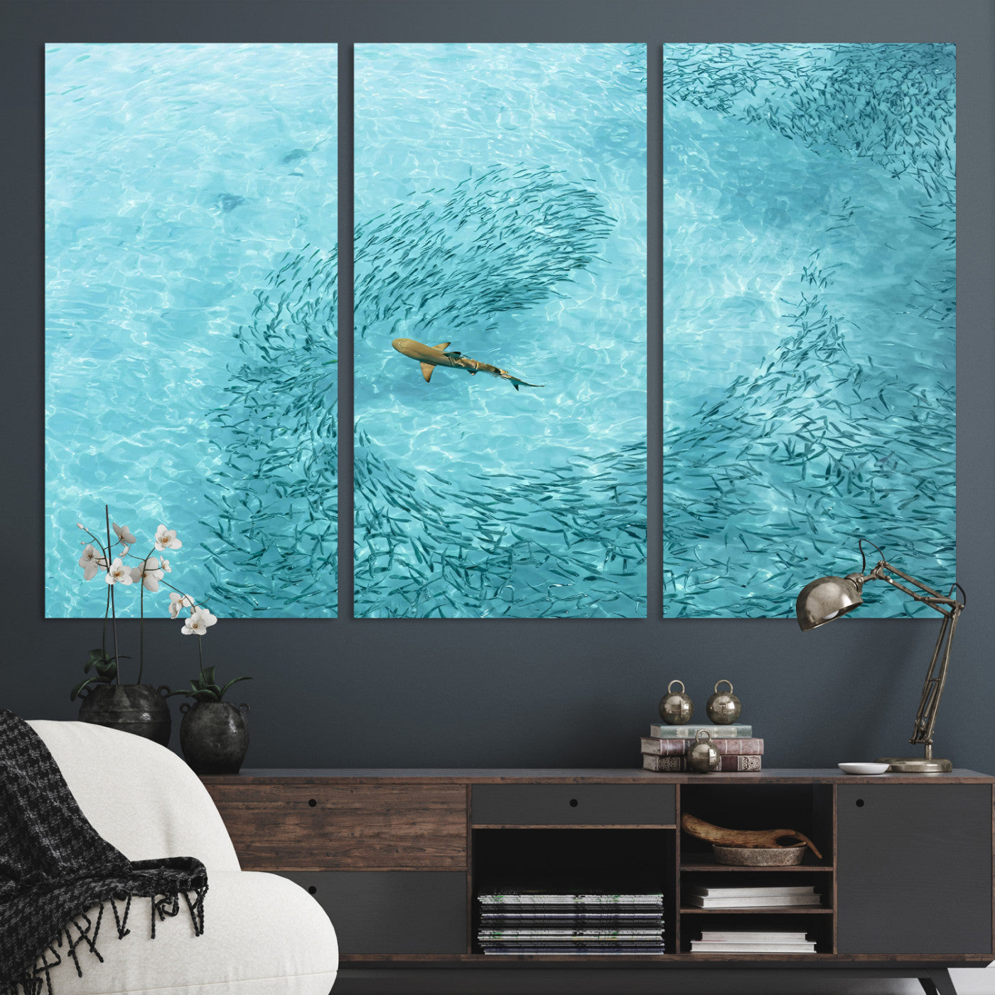 Aerial view of a shark swimming through a swirl of fish in clear turquoise waters, perfect for calm coastal or beach house decor.