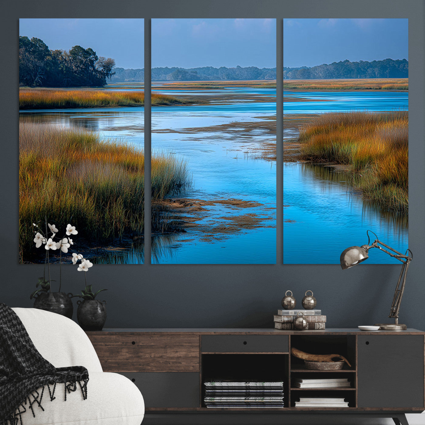 A peaceful marshland scene with calm blue water reflecting the surrounding grasses and trees, capturing the beauty of nature in a serene landscape.