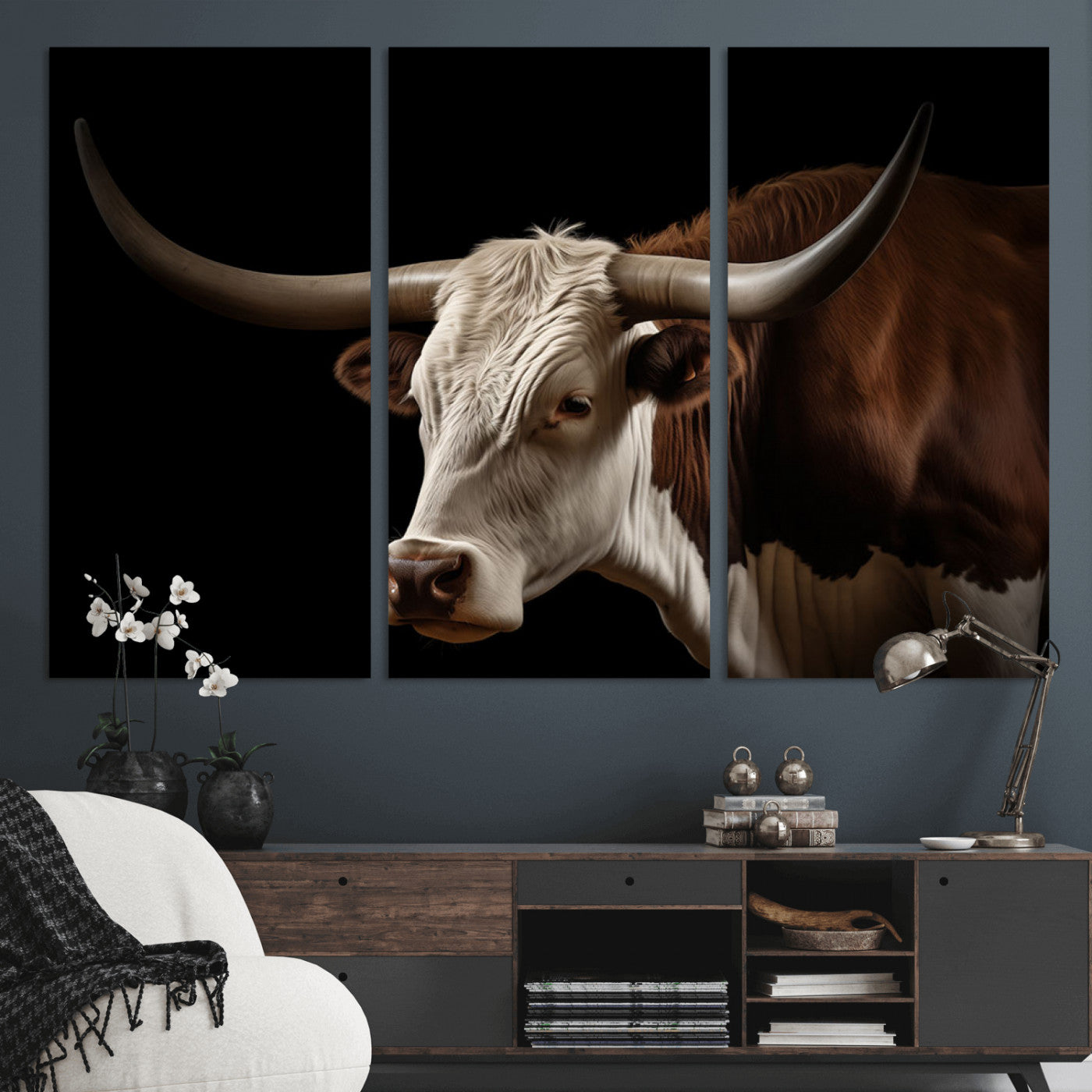 "Close-up of a brown and white longhorn cow with prominent curved horns against a black background."