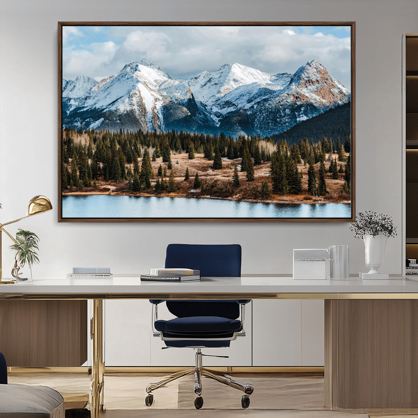 Framed canvas of snowy mountain peaks with pine forest and alpine lake, perfect for winter cabin or wilderness-inspired home decor.