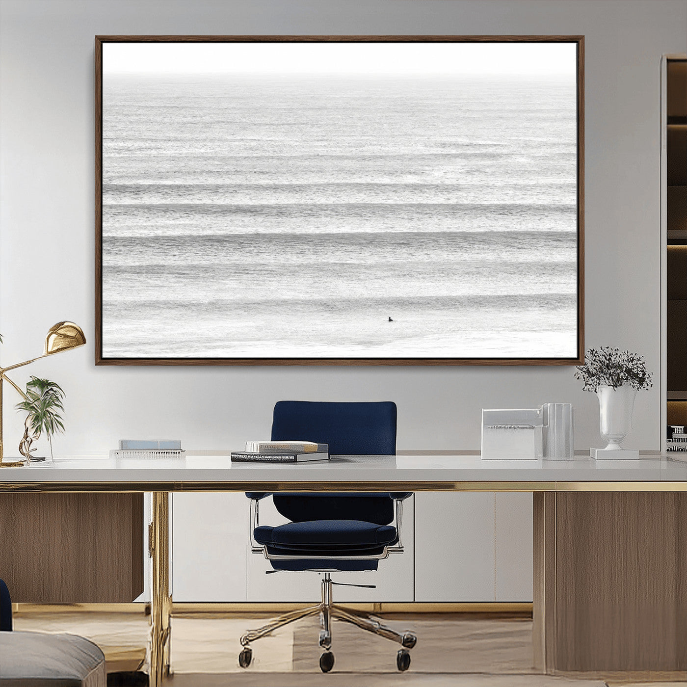 Monochrome photo of a lone surfer in calm layered waves, perfect for minimalist coastal or moody ocean-inspired wall decoration.