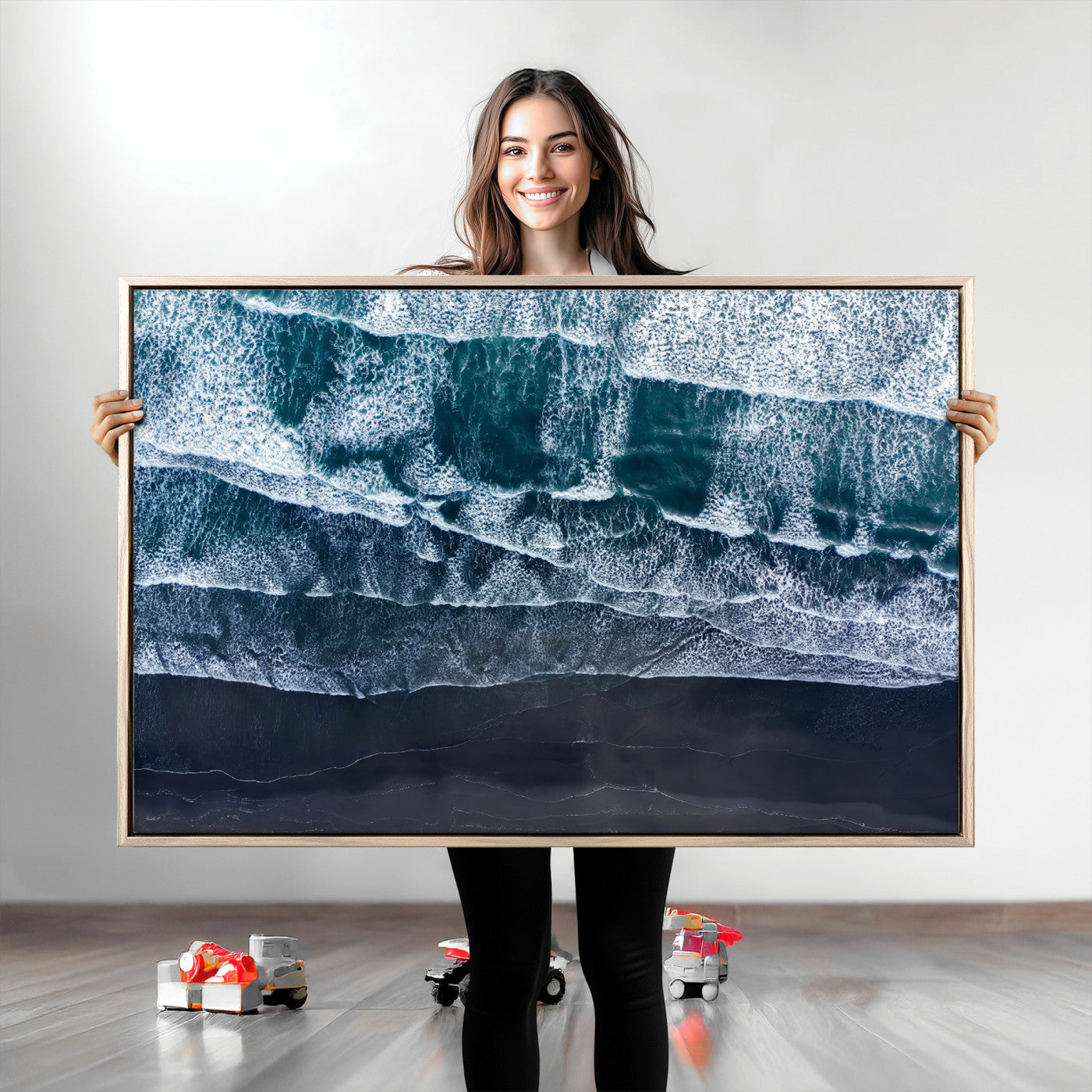 Canvas of aerial ocean waves crashing onto a black sand beach in moody tones, ideal for modern coastal or minimalist home decor.