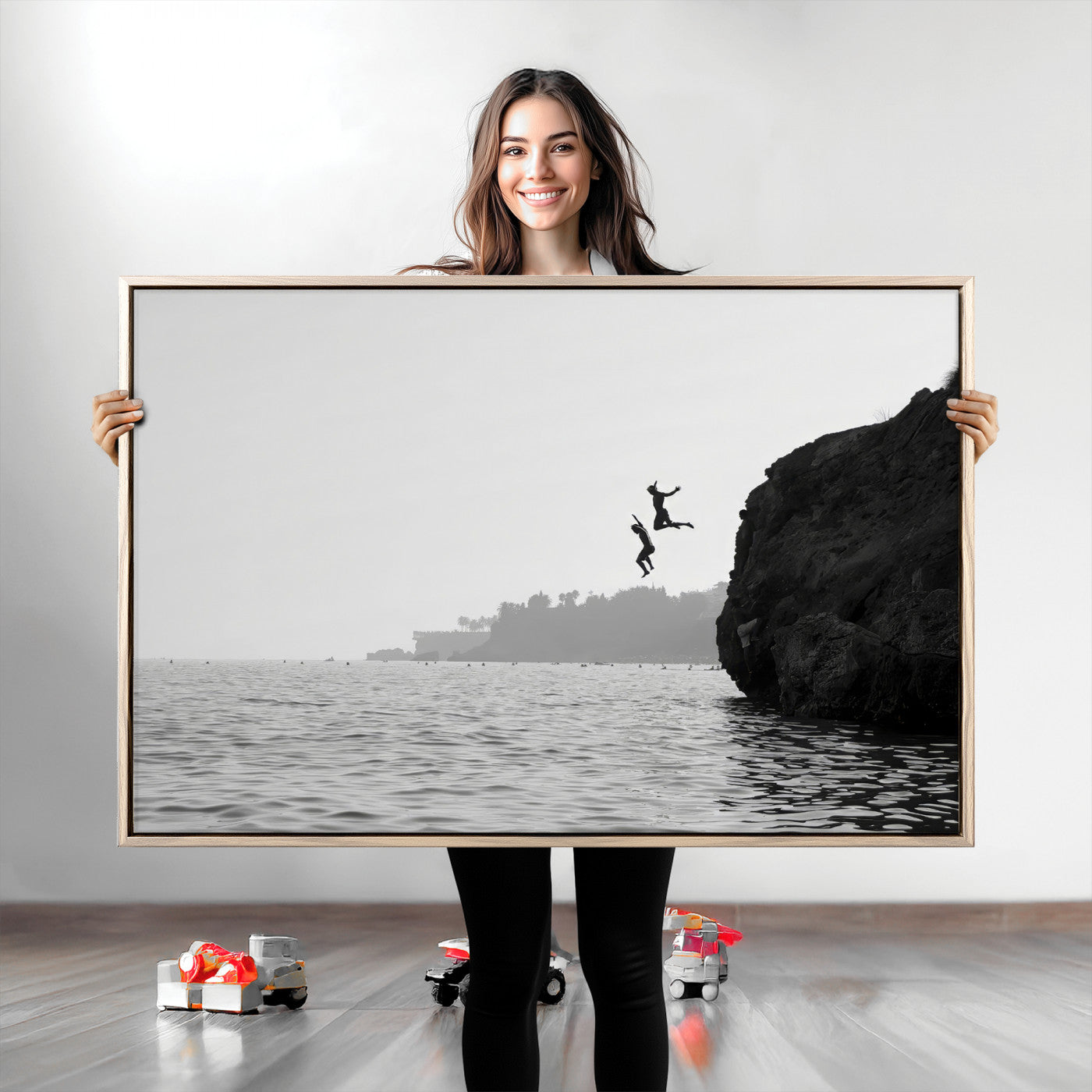 Black and white canvas of two figures cliff jumping into the sea, captured with moody tones, ideal for modern coastal or adventure-themed home decor. 2/2
