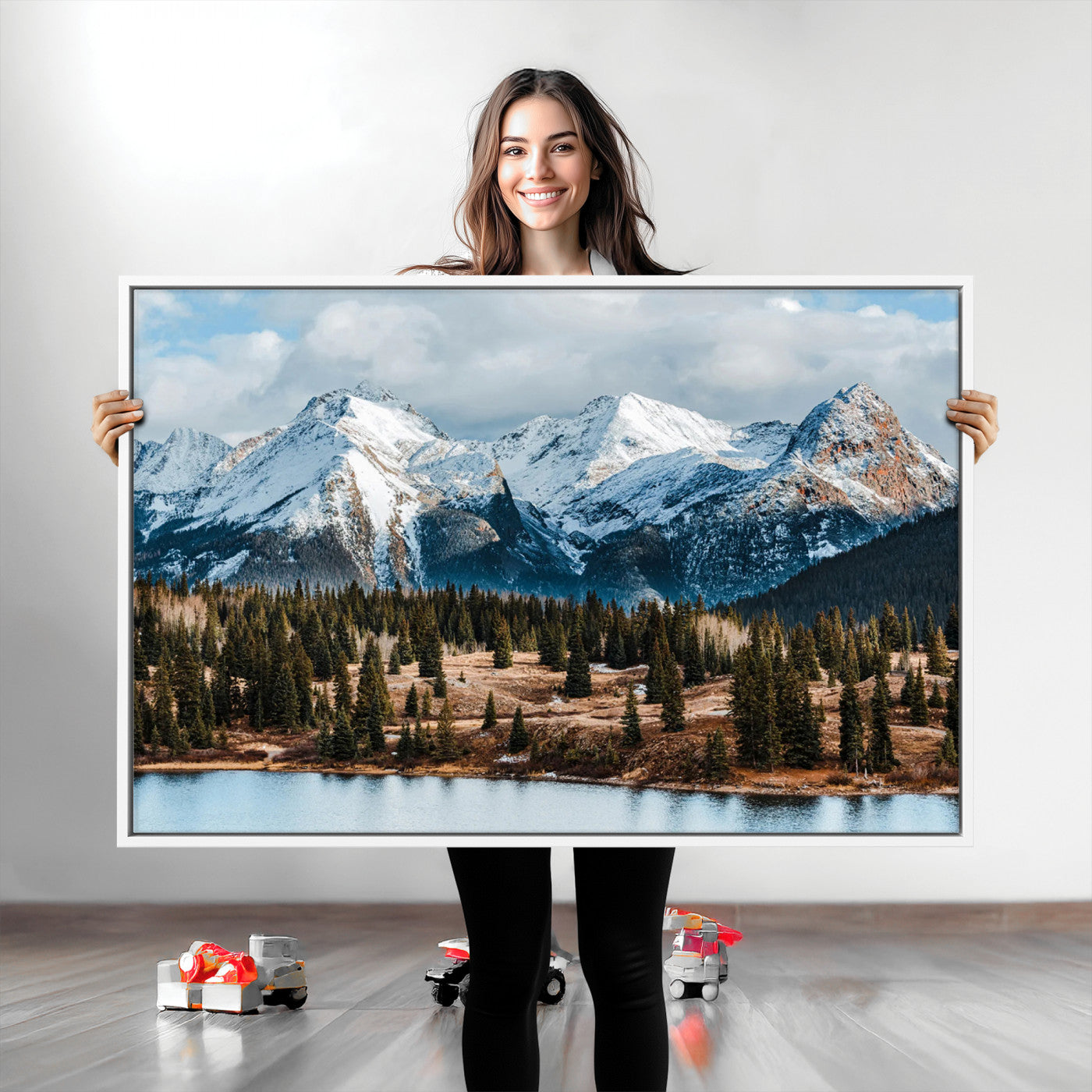 Framed canvas of snowy mountain peaks with pine forest and alpine lake, perfect for winter cabin or wilderness-inspired home decor.