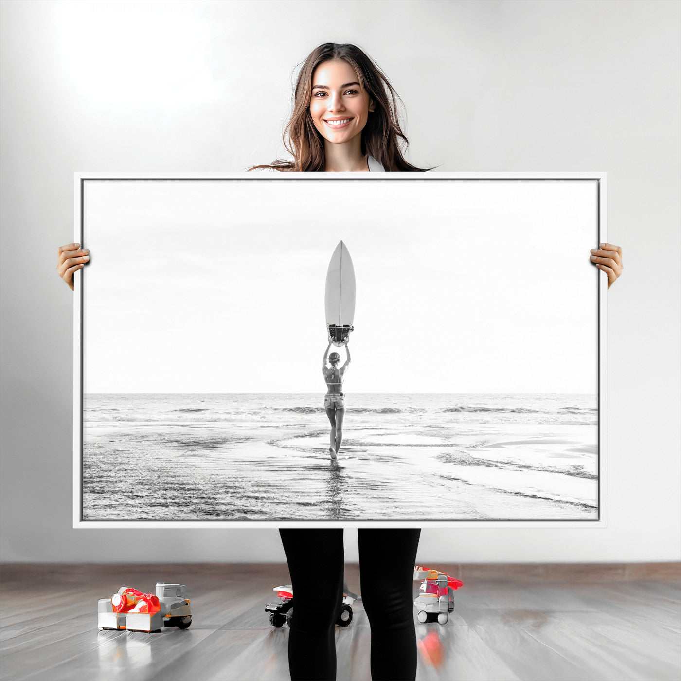 Black and white image of a female surfer holding a surfboard above her head while walking toward the ocean, creating a minimalist and bold coastal aesthetic.