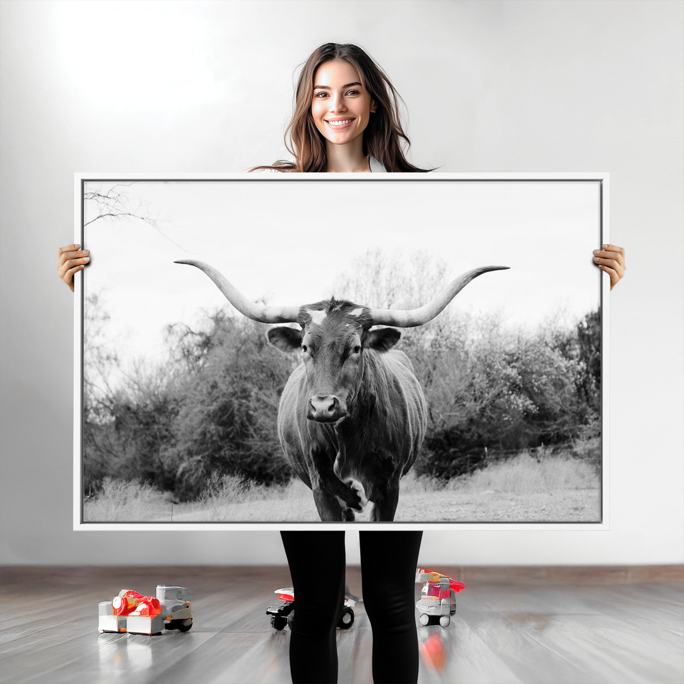 Black and white photo of a longhorn cow in a field, perfect for rustic farmhouse or western-themed interior wall decoration.