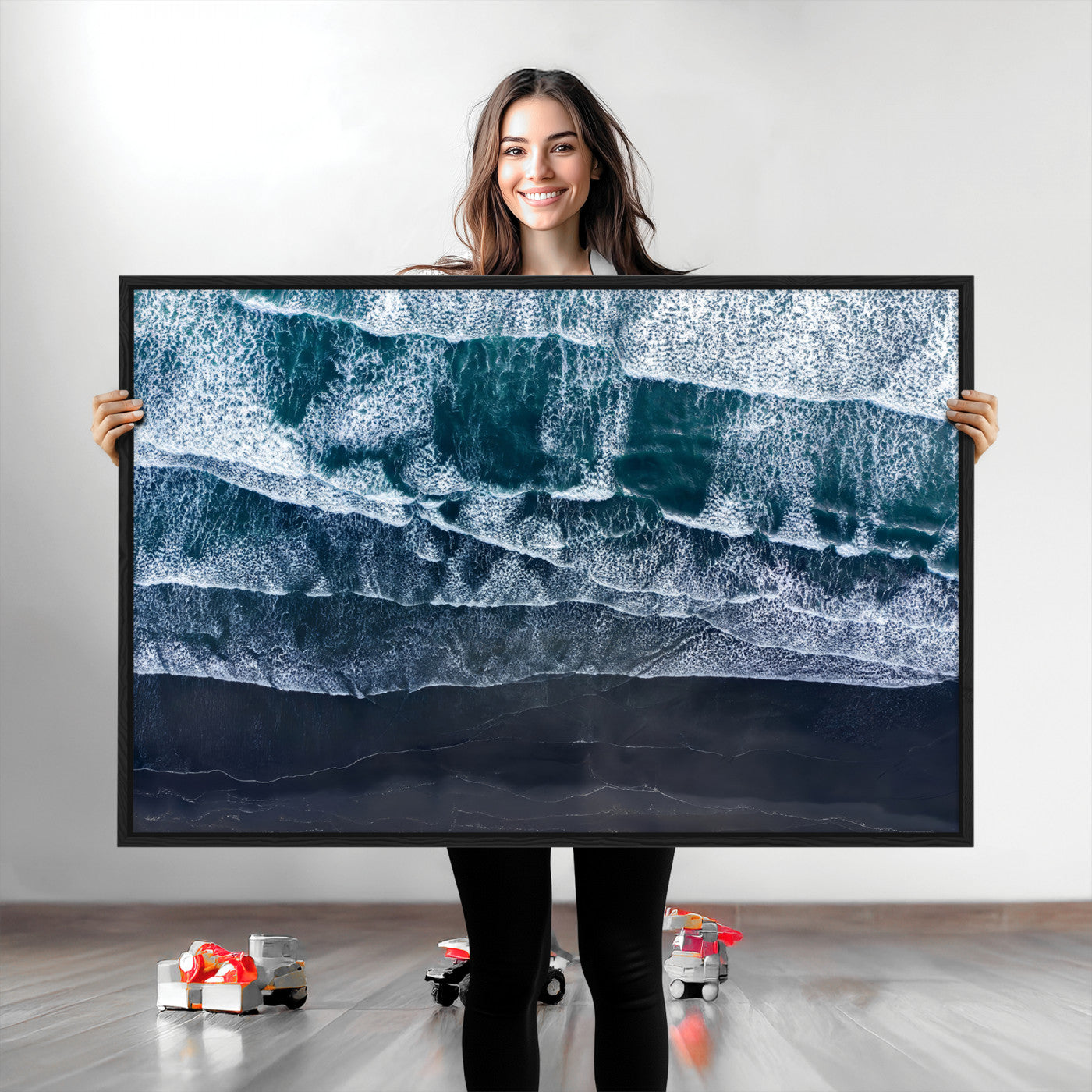 Canvas of aerial ocean waves crashing onto a black sand beach in moody tones, ideal for modern coastal or minimalist home decor.