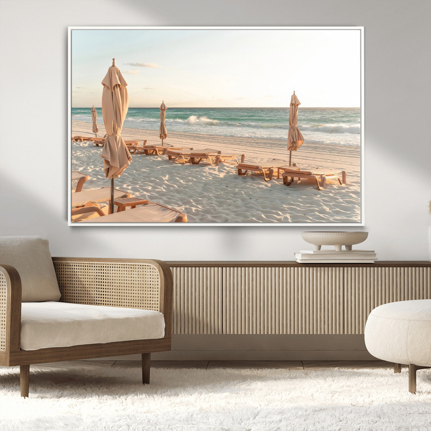 Minimalist photo of empty beach loungers and umbrellas on soft sand, ideal for calm seaside or pastel coastal-style home decor.