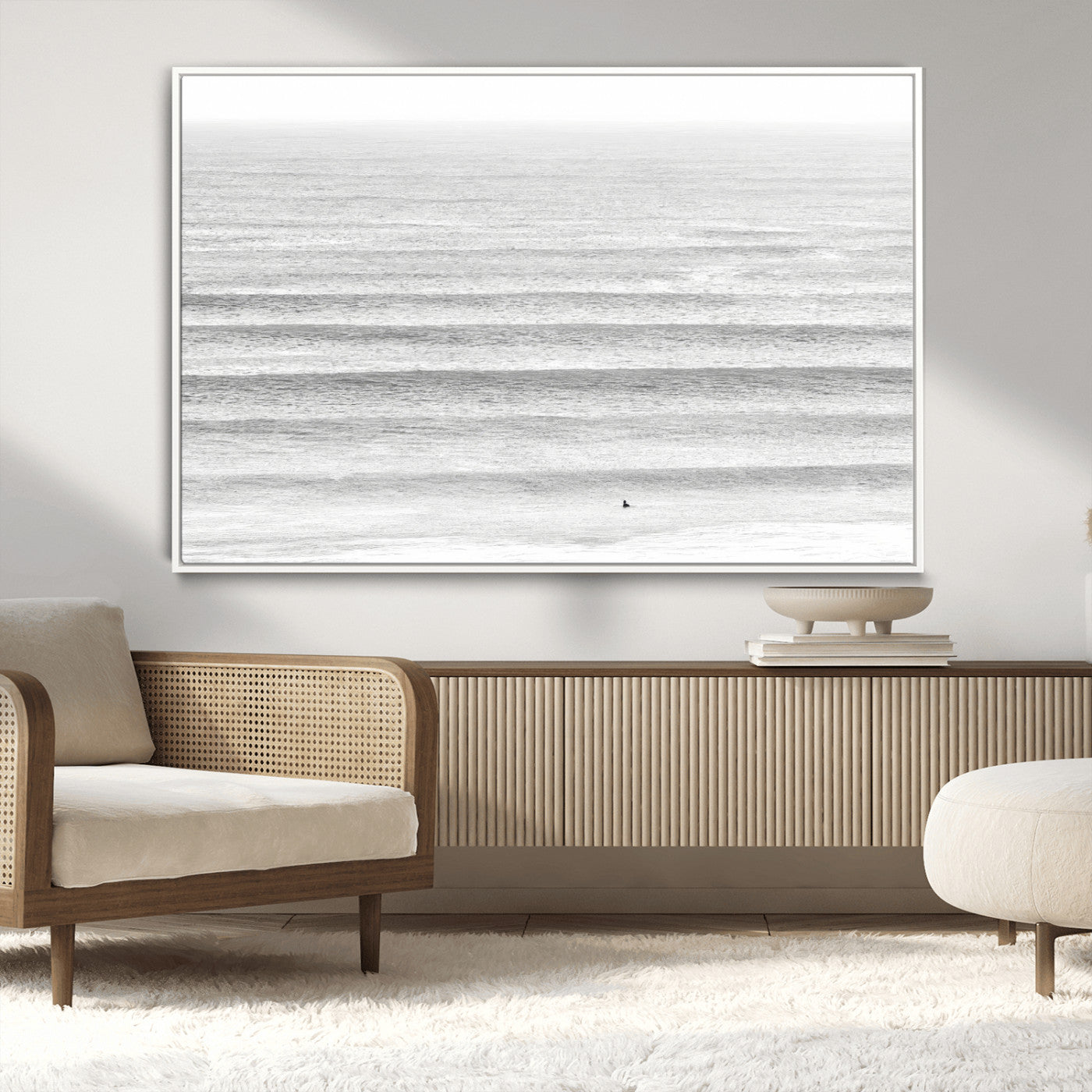 Monochrome photo of a lone surfer in calm layered waves, perfect for minimalist coastal or moody ocean-inspired wall decoration.