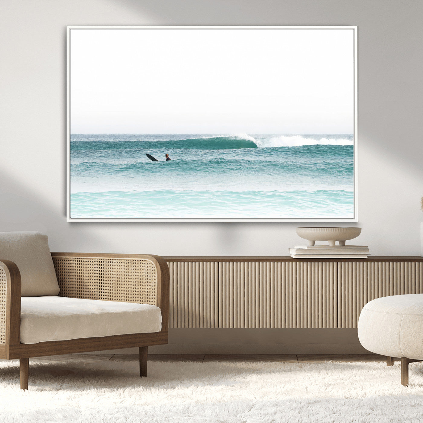 Minimalist photo of a lone surfer on calm aqua waves under bright sky, perfect for Scandinavian coastal or serene ocean-inspired home decor.