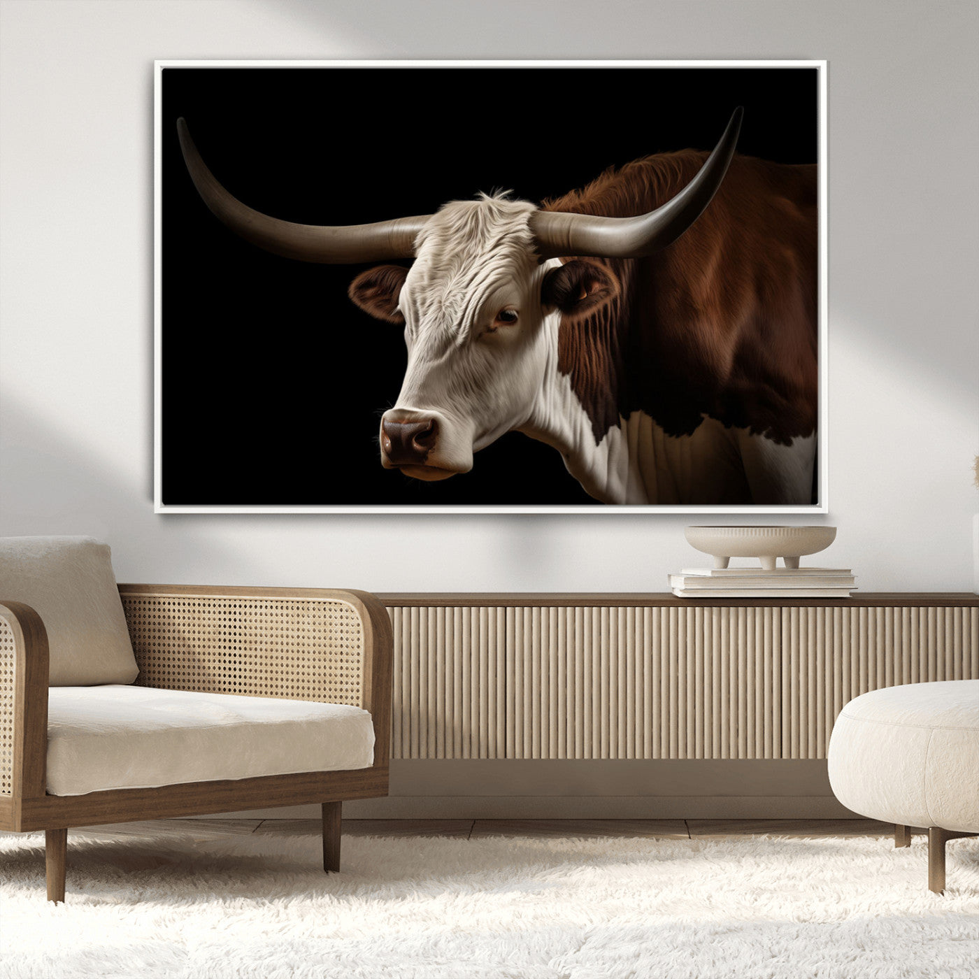 "Close-up of a brown and white longhorn cow with prominent curved horns against a black background."