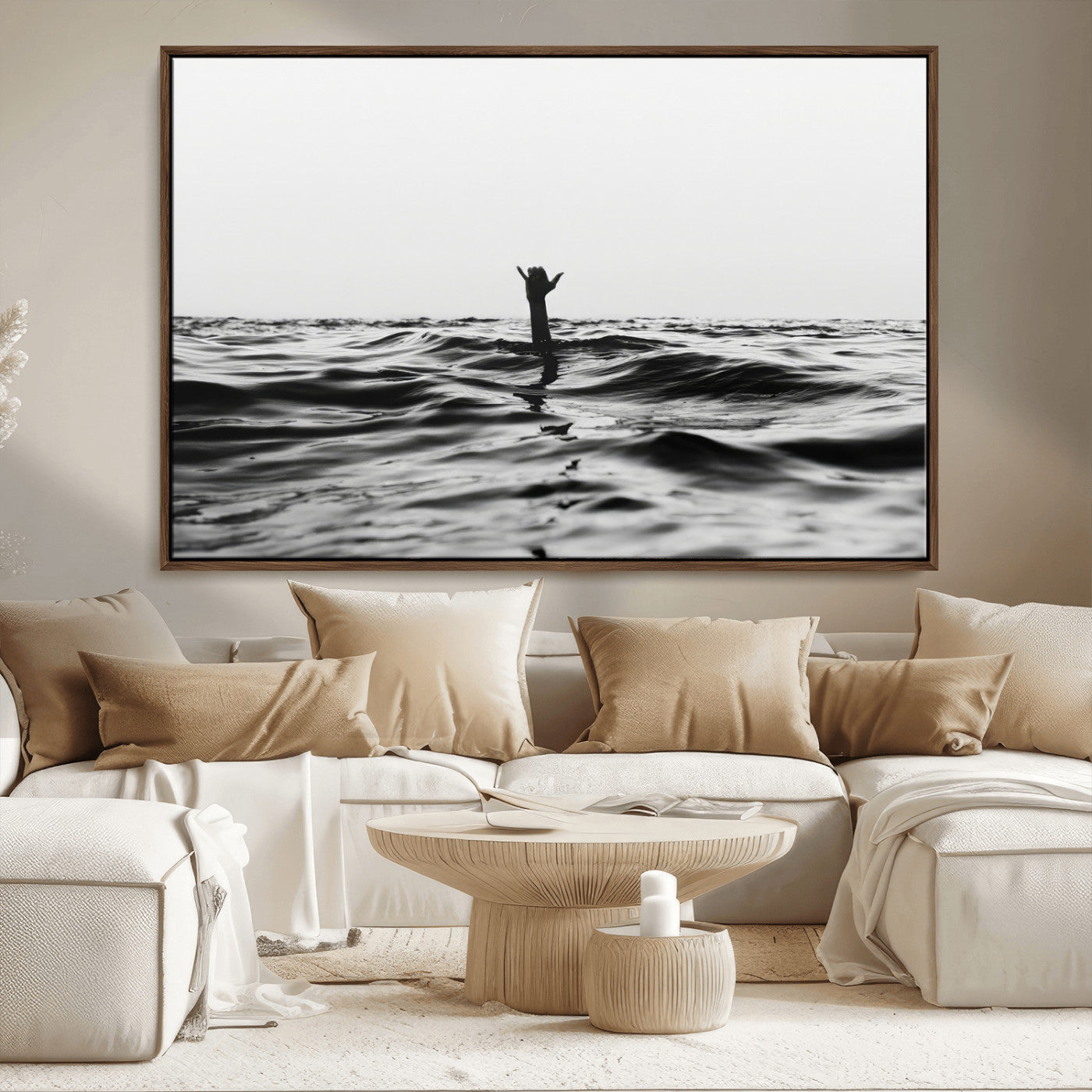 Black and white ocean with a hand making a surfer sign among dark waves, creating a dramatic and minimalist seascape with bold contrast.