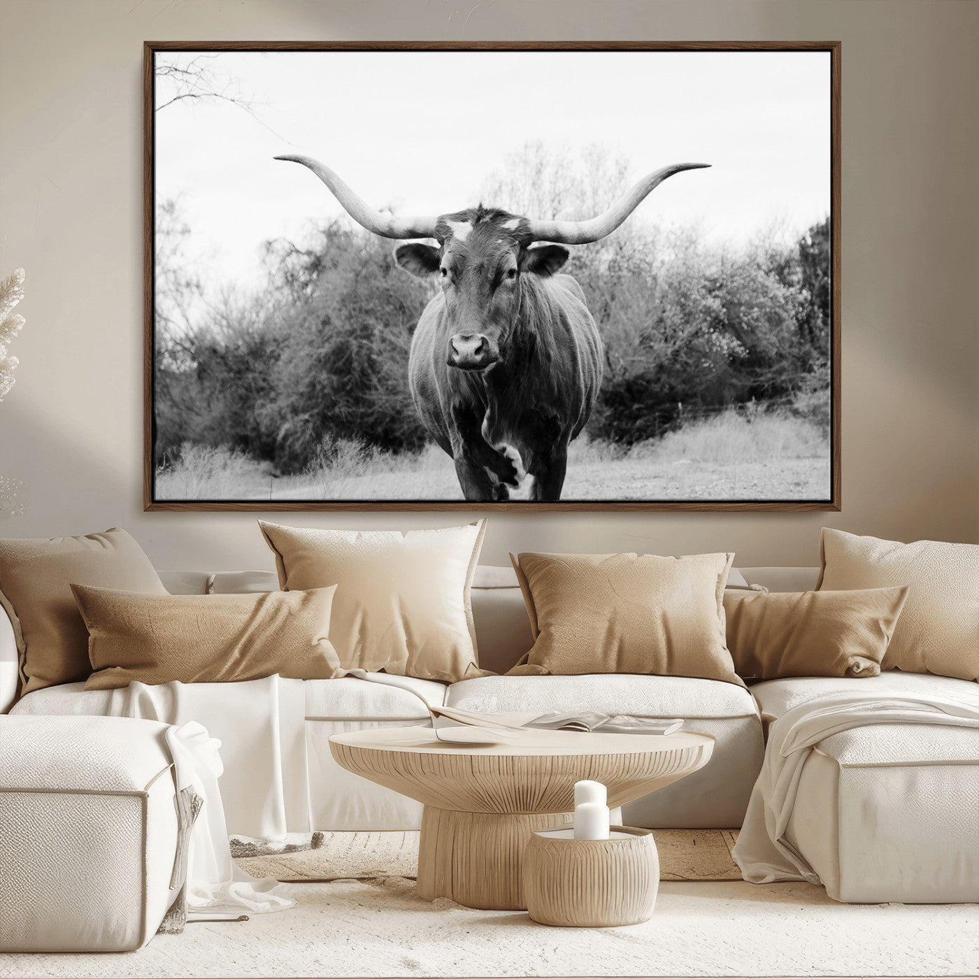 Black and white photo of a longhorn cow in a field, perfect for rustic farmhouse or western-themed interior wall decoration.