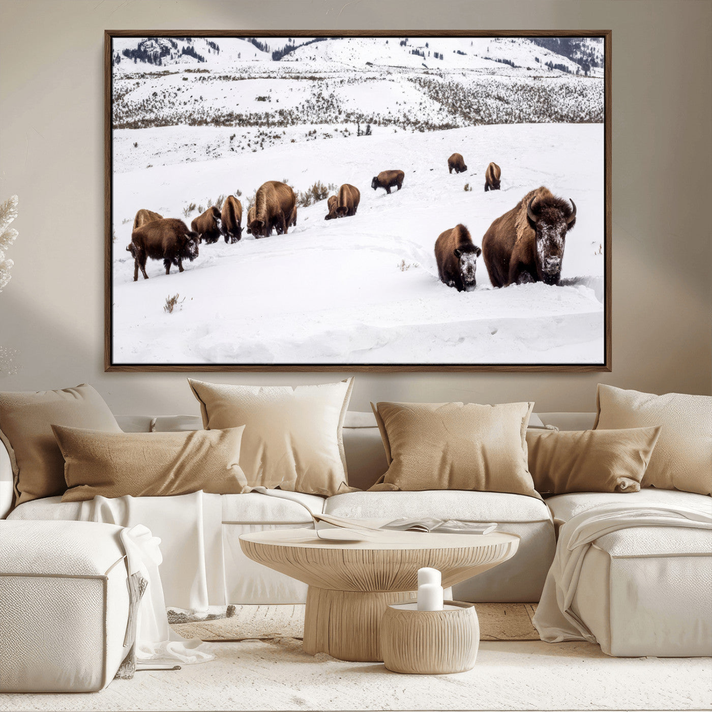 A herd of bison walking through deep snow in a mountain valley, perfect for rustic, cabin or western-themed wall decor.