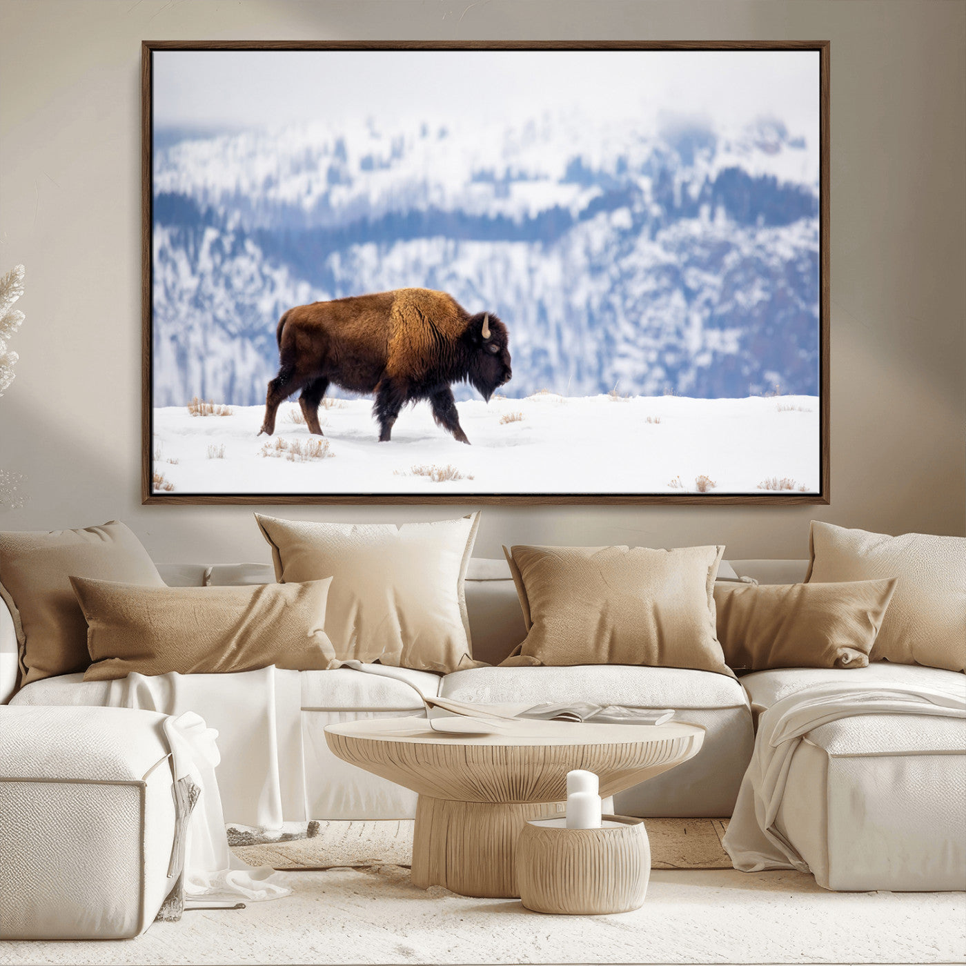 A lone bison walks across snowy ground with blue-toned mountain range behind, ideal for rustic or western farmhouse interiors.