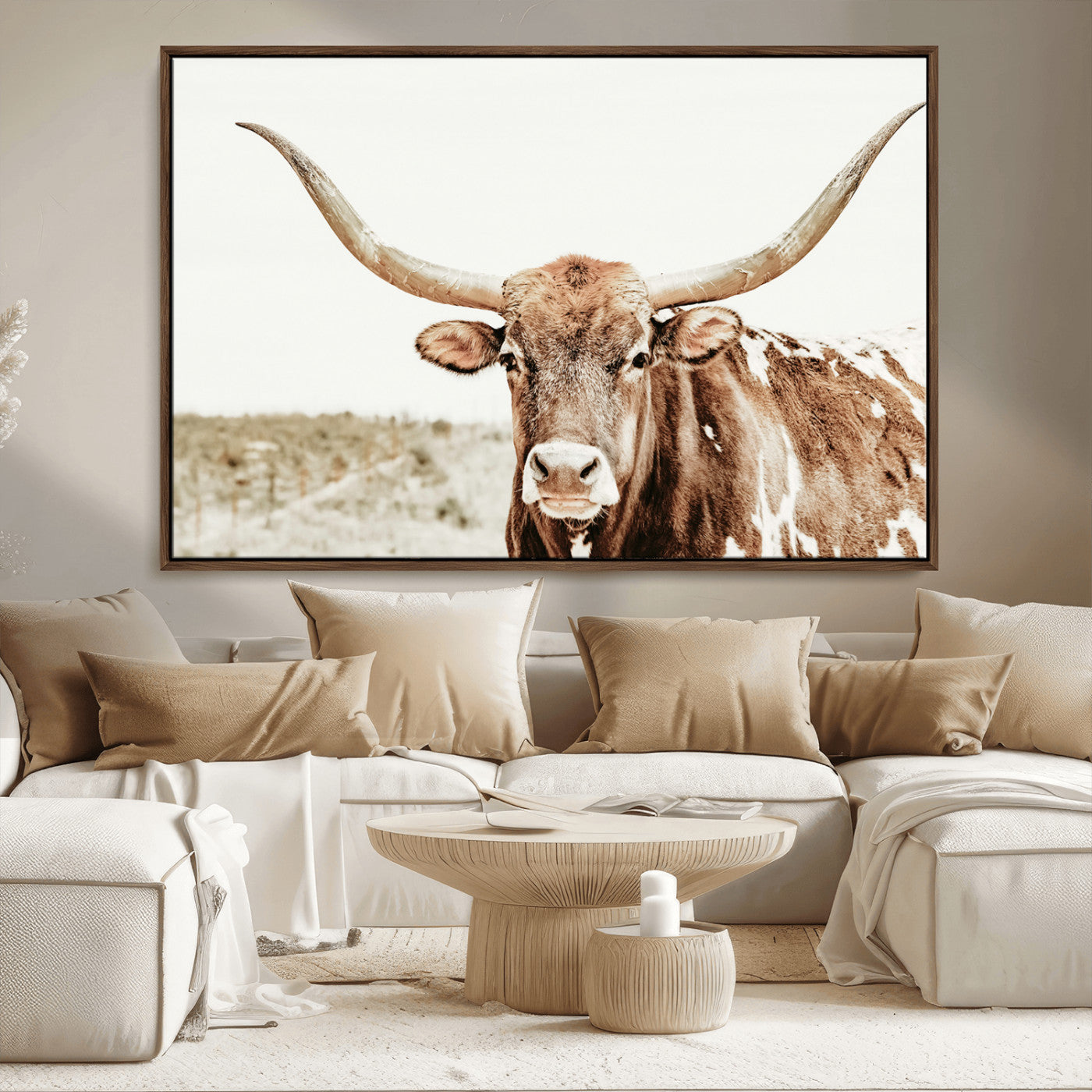 A Texas longhorn bull with wide horns, standing in a dry field under soft light, ideal for rustic farmhouse or western-themed interiors.