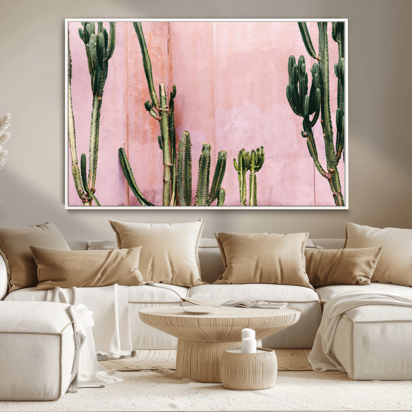 Framed canvas of tall green cacti against a soft pink wall, ideal for modern desert or colorful southwest-inspired home decor.