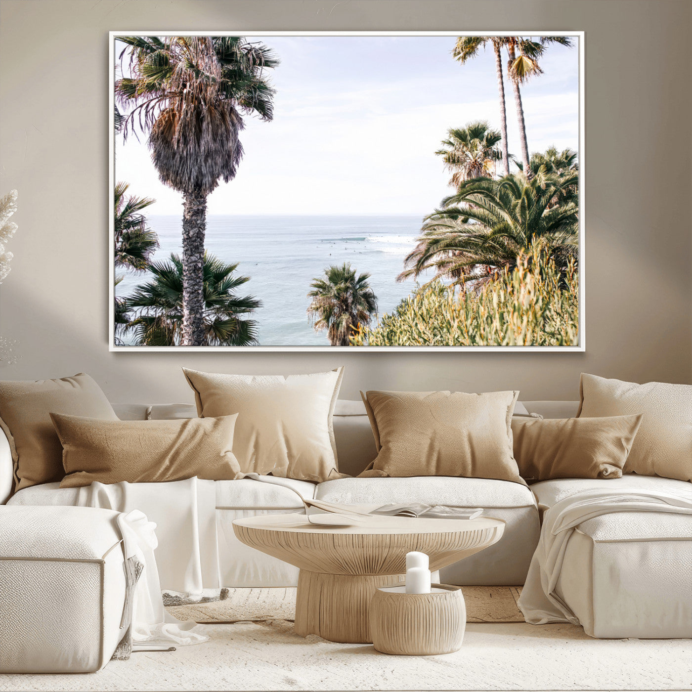Scenic coastal view with tall palm trees overlooking a calm ocean, soft blue waves, and surfers in the distance, creating a peaceful tropical vibe.