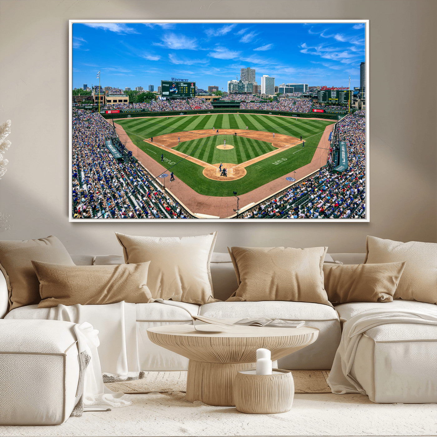A wide-angle shot of a baseball field filled with spectators, with players on the field and the iconic Wrigley Field scoreboard in the background.