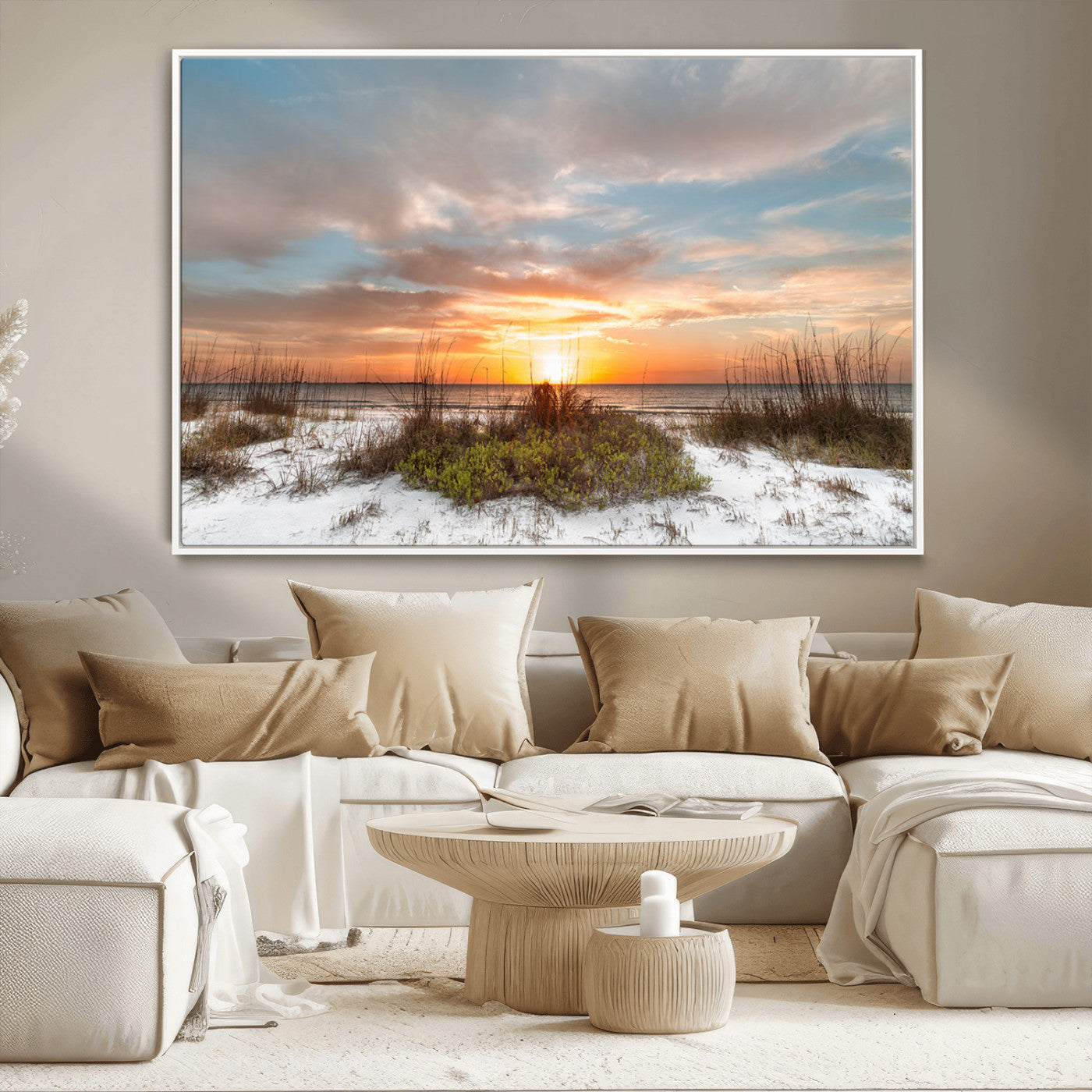 A tranquil beach scene featuring golden sunset hues over the water, with grasses in the foreground and a peaceful, serene atmosphere.