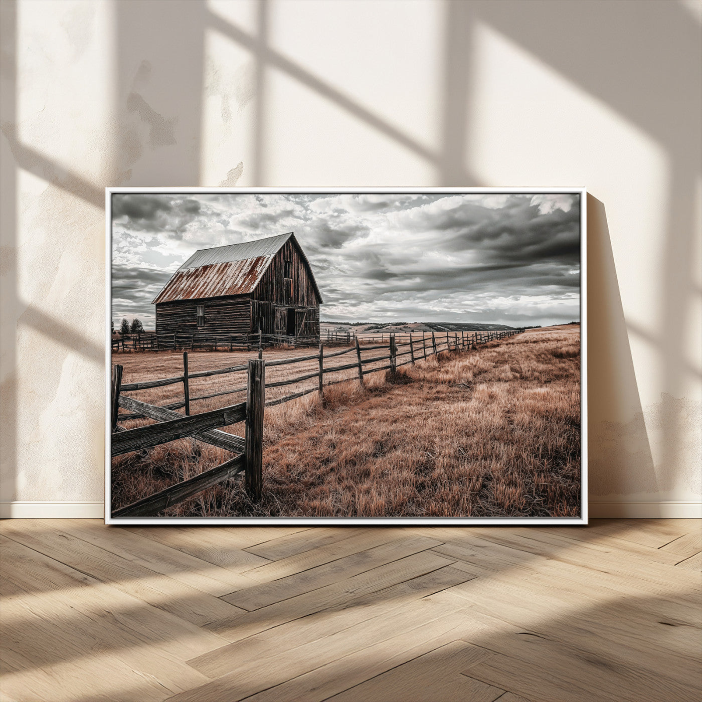 Framed canvas of a rustic barn under a moody sky with weathered fence and dark fields, ideal for farmhouse or rural-style wall decor.