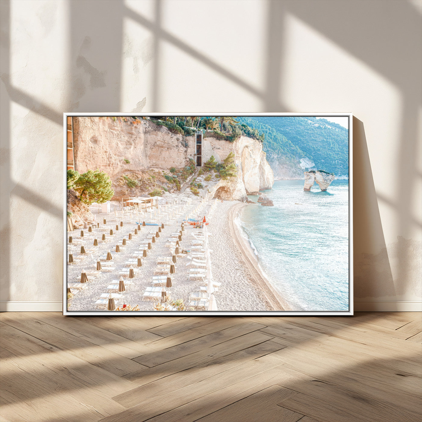 Wall art of a calm Mediterranean beach with rows of sun loungers and umbrellas in soft pastel tones, perfect for light coastal or vacation-themed decor.
