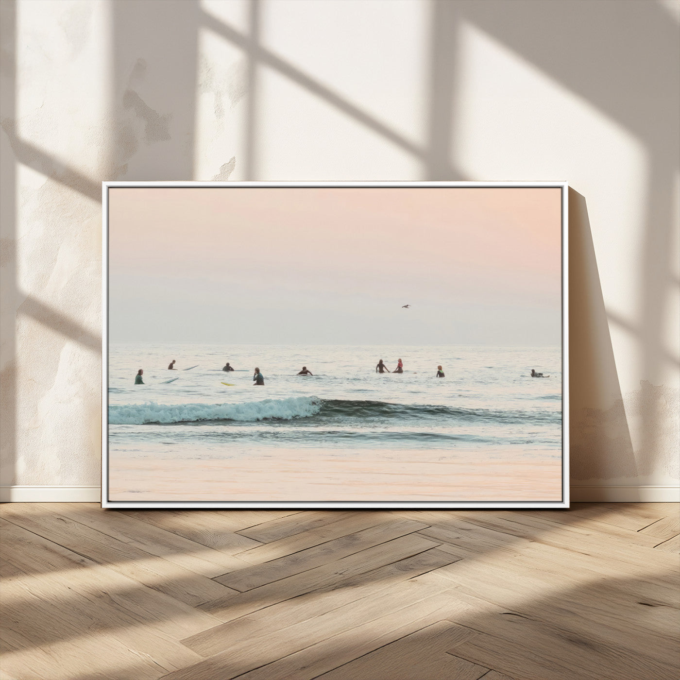 Dreamy photo of surfers waiting on soft pastel waves under a pink sunset sky, ideal for soft coastal minimalist or serene ocean-themed home decor.