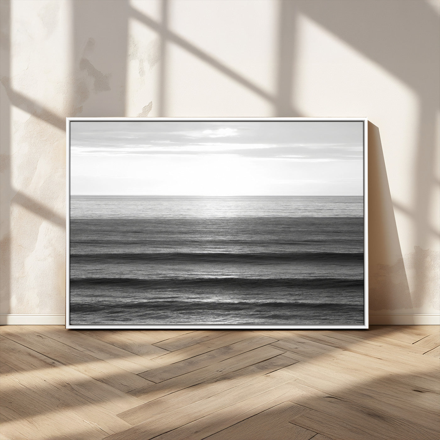 Minimalist black and white ocean view with layered waves reflecting sunlight, evoking a sense of calm and coastal serenity.