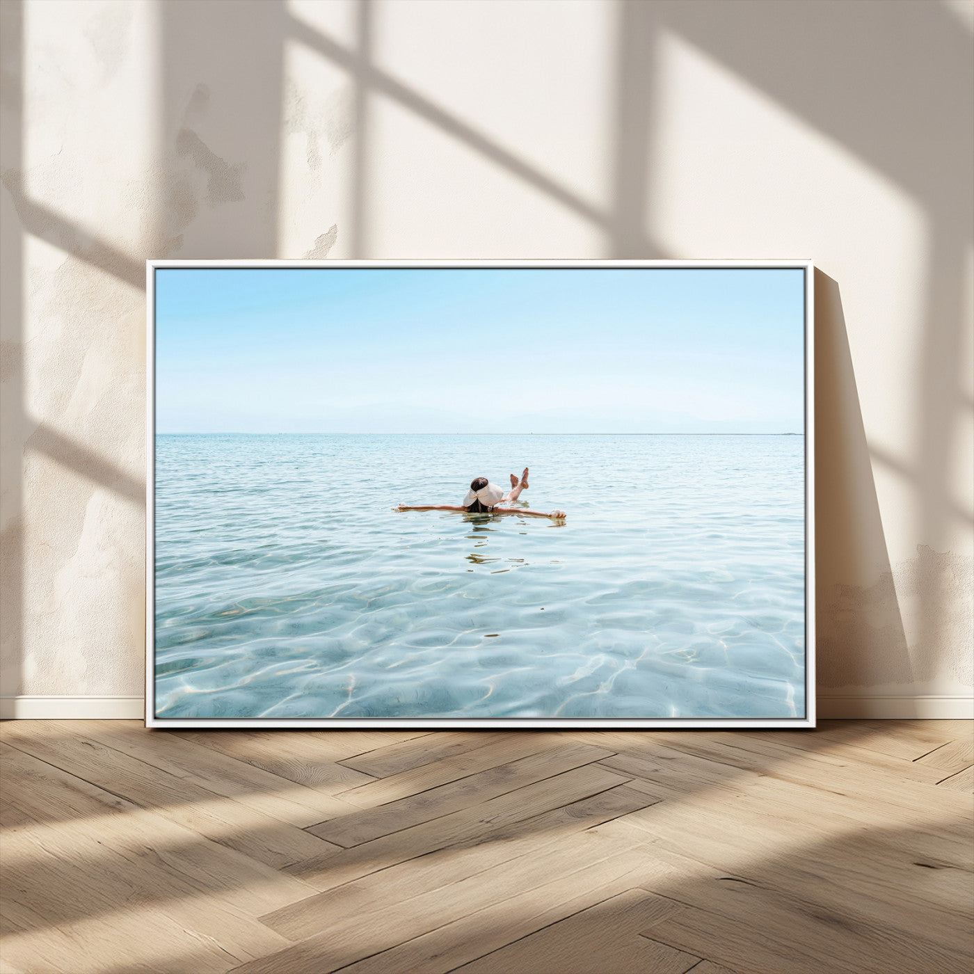 A peaceful minimalist scene of a person floating on crystal-clear water, surrounded by a vast open horizon, capturing relaxation and serenity in a tranquil aquatic setting.
