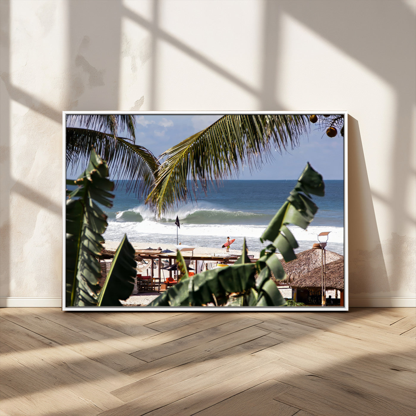Canvas wall art of a tropical surf scene framed by palm trees, with a surfer on the shore and waves rolling in, ideal for beach-themed decor.