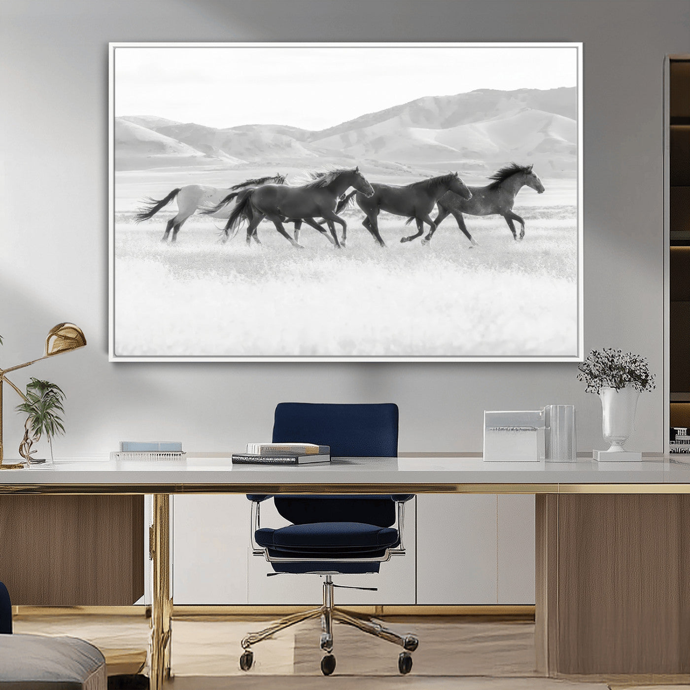 A black and white image of wild horses running freely across an open grassland, capturing the power and beauty of untamed nature in a rustic western setting.
