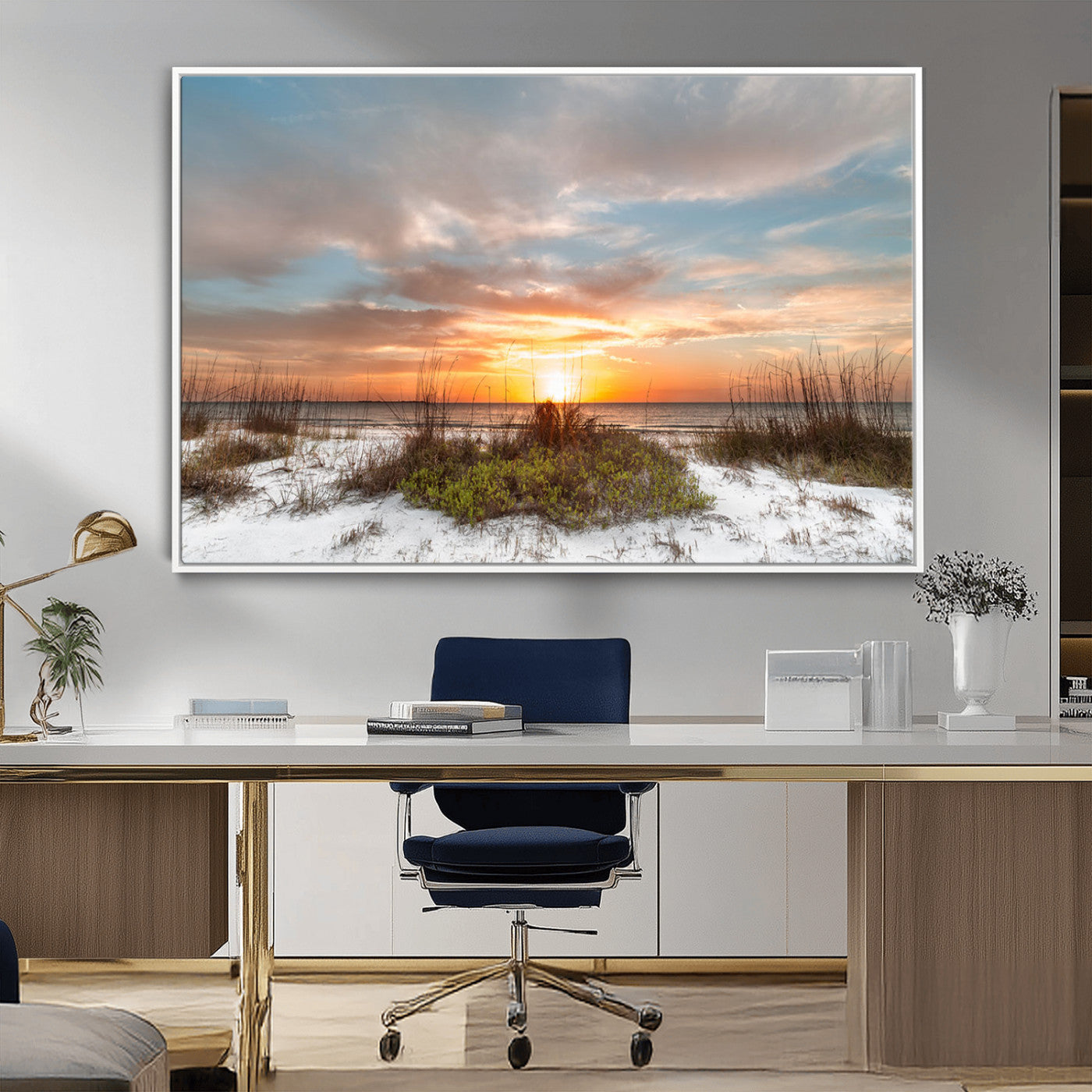 A tranquil beach scene featuring golden sunset hues over the water, with grasses in the foreground and a peaceful, serene atmosphere.