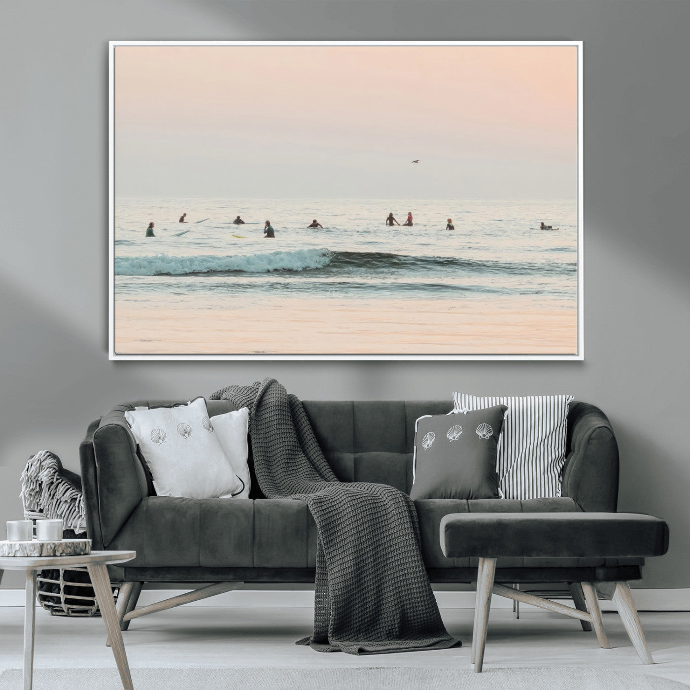 Dreamy photo of surfers waiting on soft pastel waves under a pink sunset sky, ideal for soft coastal minimalist or serene ocean-themed home decor.