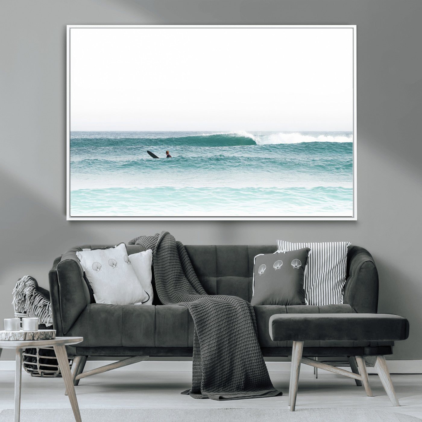 Minimalist photo of a lone surfer on calm aqua waves under bright sky, perfect for Scandinavian coastal or serene ocean-inspired home decor.