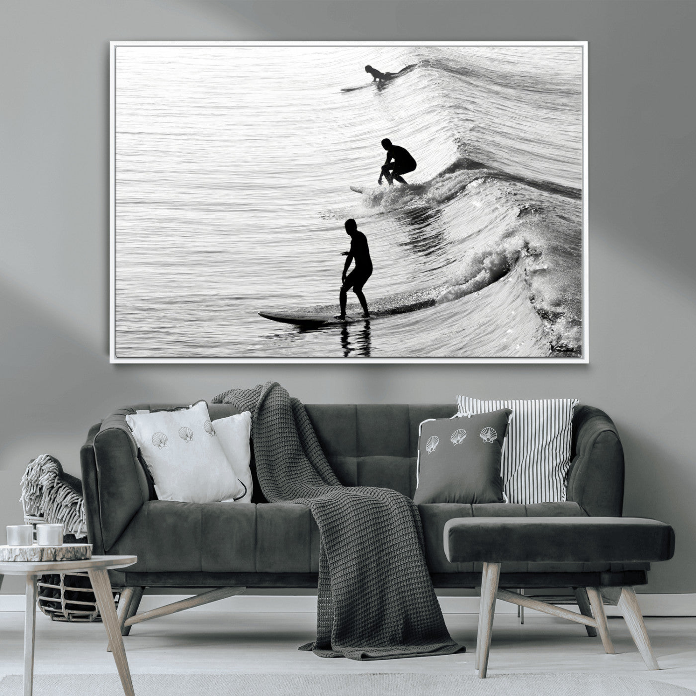 Black and white photo of surfers riding waves in a moody, high-contrast scene, ideal for modern coastal or surf-inspired home decor.
