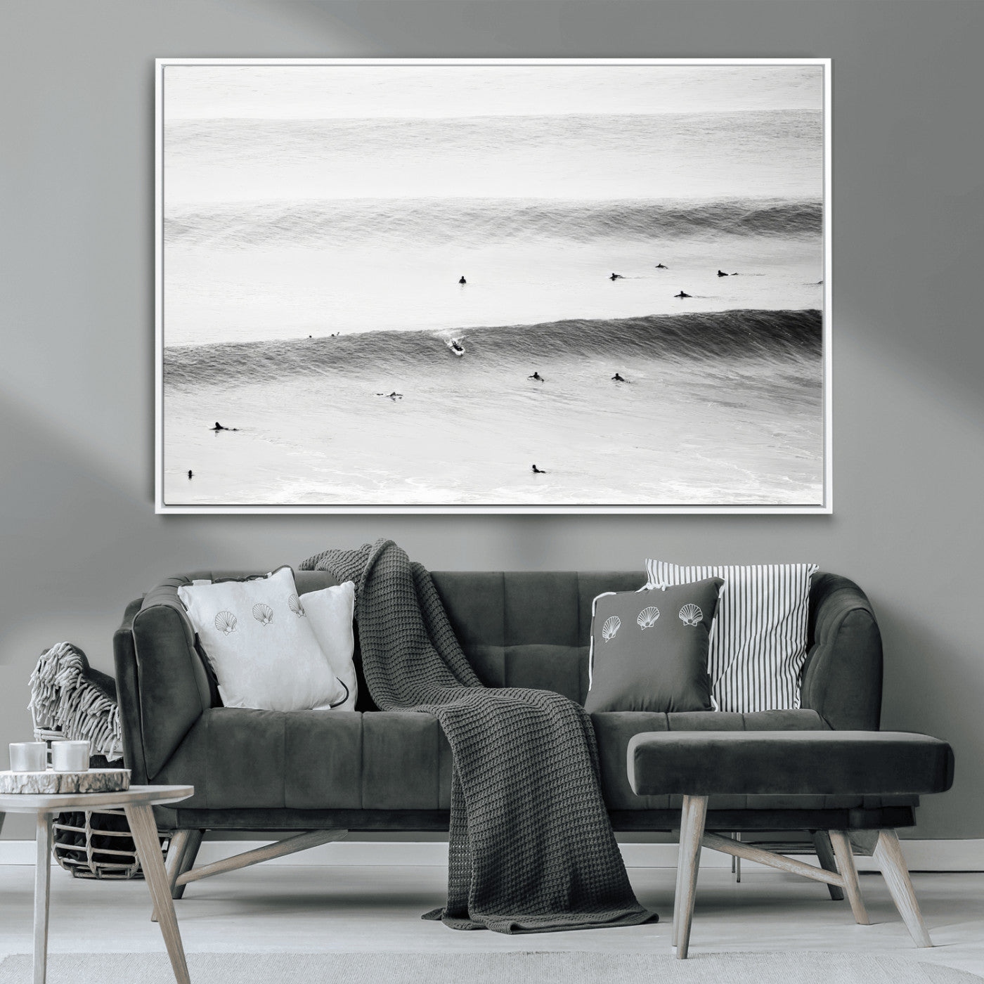 A monochrome photograph of swimmers gliding through gentle ocean waves, evoking a sense of calm and movement.