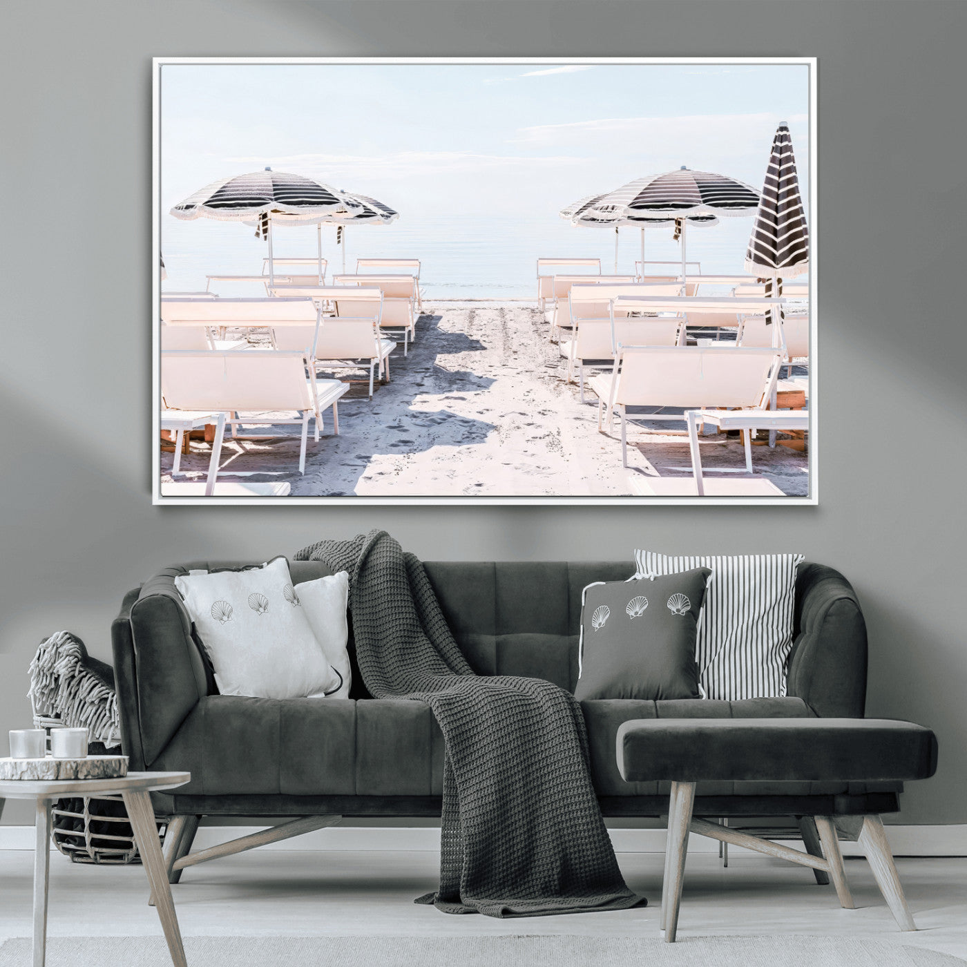 A serene minimalist beach scene featuring striped umbrellas, soft pastel sand, and an elegant lounge setup, creating a tranquil and stylish coastal retreat.