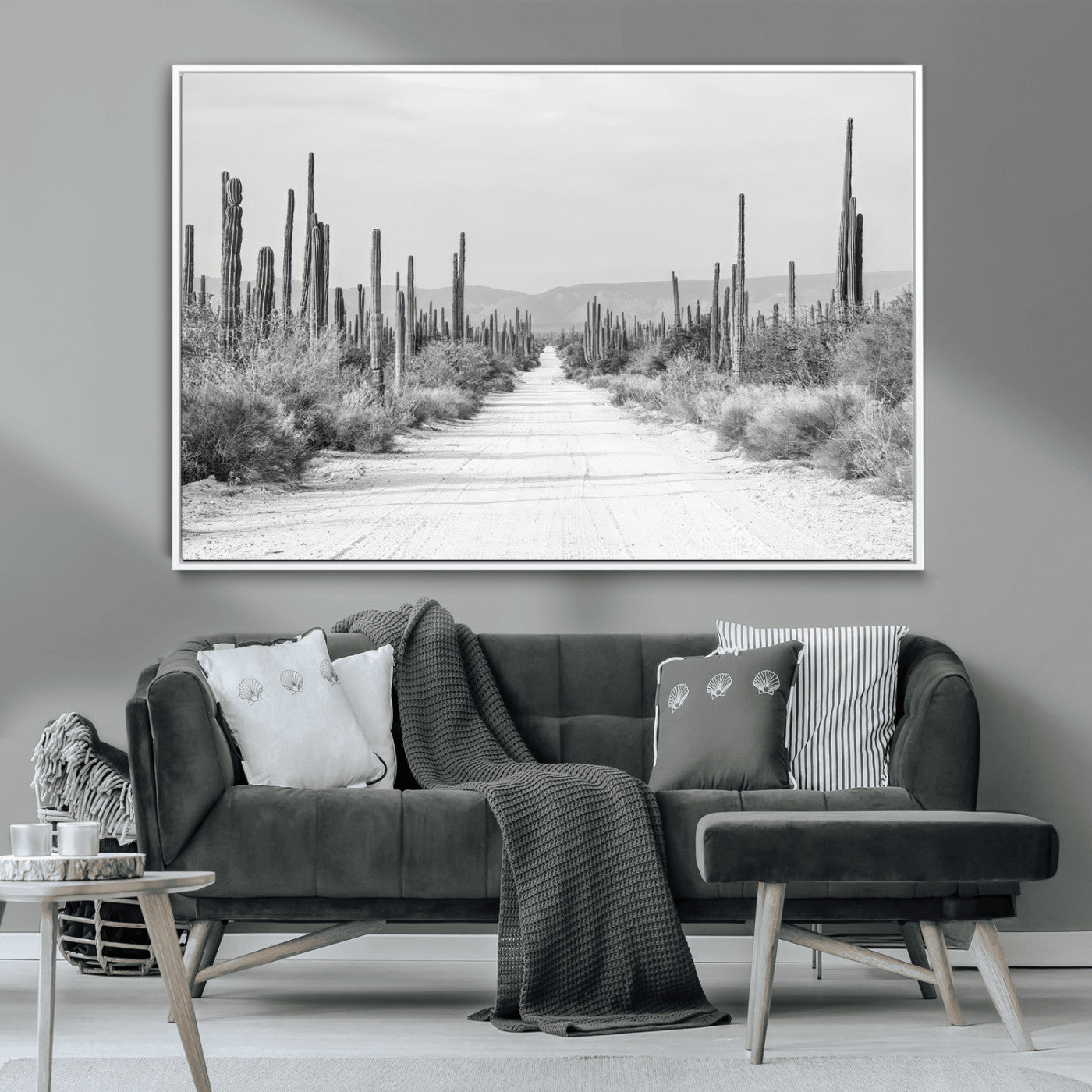 A black and white desert road stretching through a cactus-filled landscape, creating a rugged and timeless southwestern aesthetic with a sense of adventure.