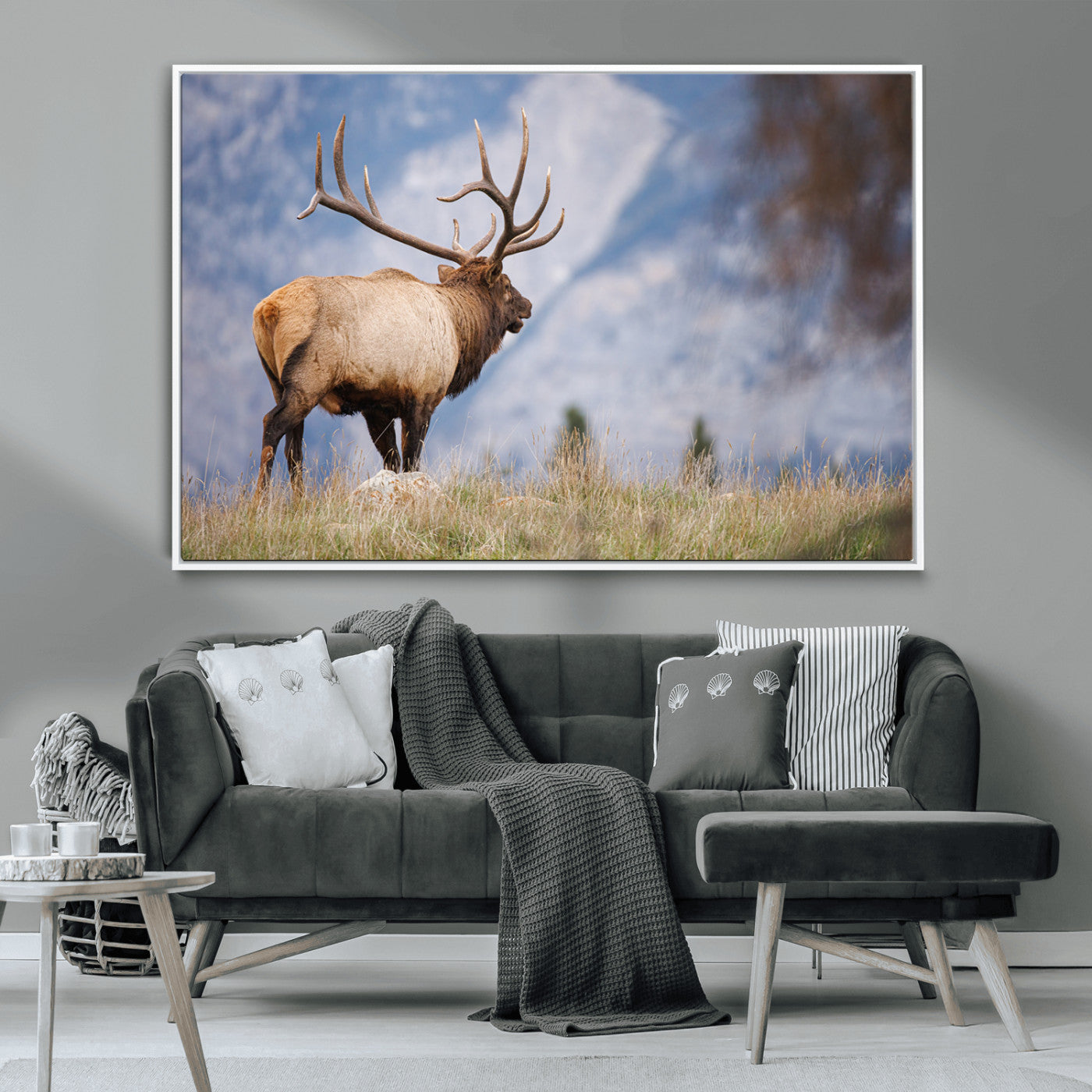 Elk with antlers standing on grass with mountain background, ideal for rustic, cabin, or lodge-inspired wall decor.