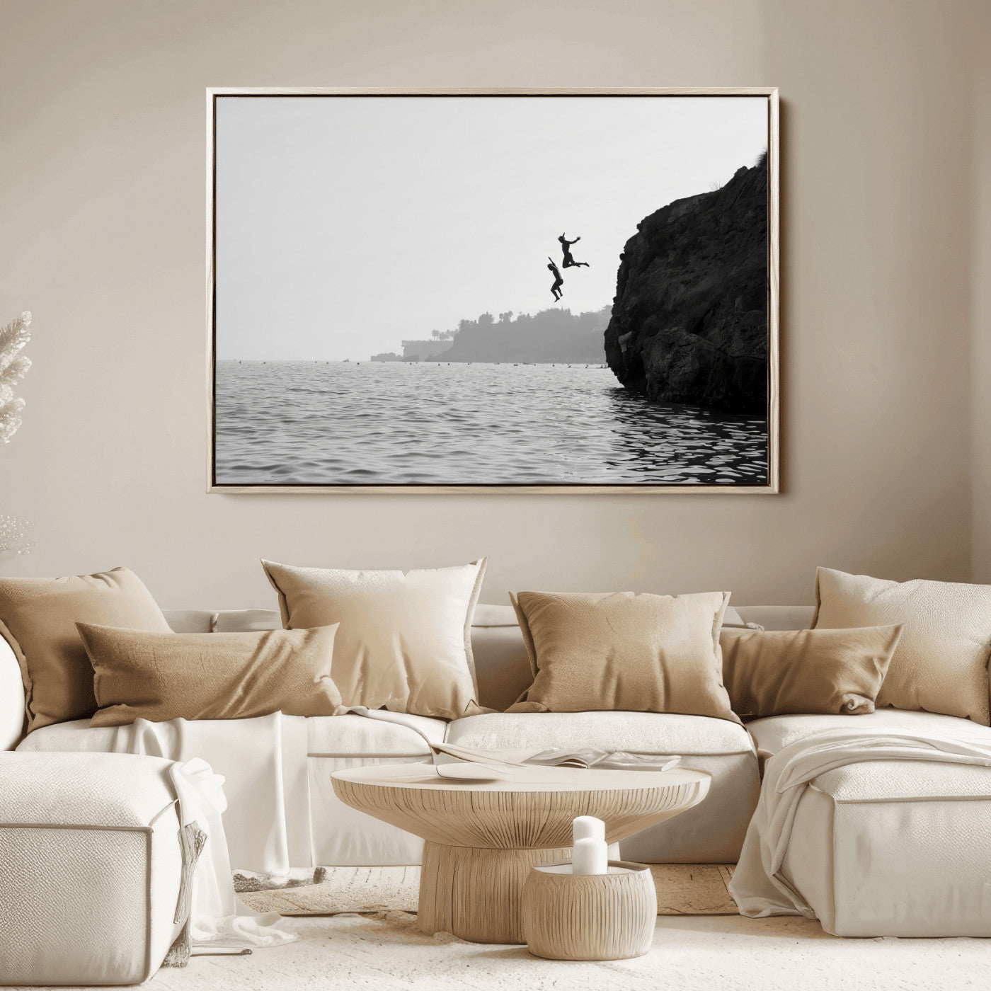 Black and white canvas of two figures cliff jumping into the sea, captured with moody tones, ideal for modern coastal or adventure-themed home decor. 2/2