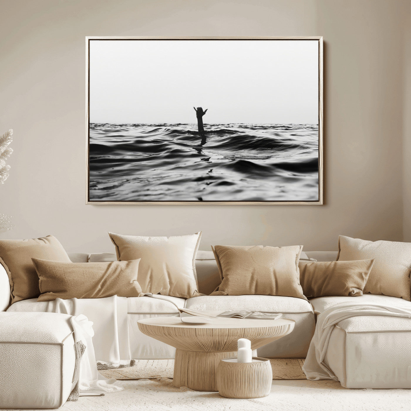 Black and white ocean with a hand making a surfer sign among dark waves, creating a dramatic and minimalist seascape with bold contrast.