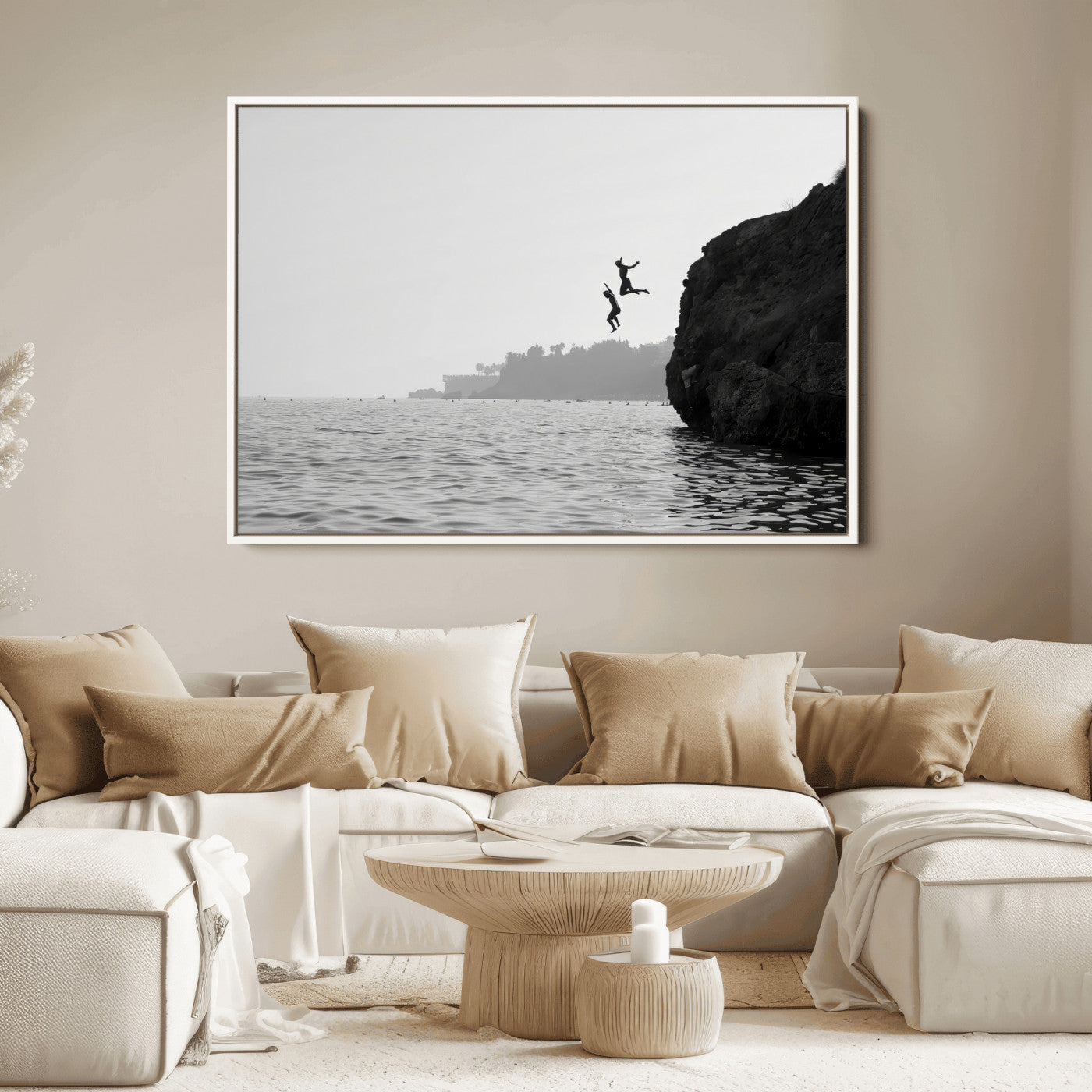 Black and white canvas of two figures cliff jumping into the sea, captured with moody tones, ideal for modern coastal or adventure-themed home decor. 2/2
