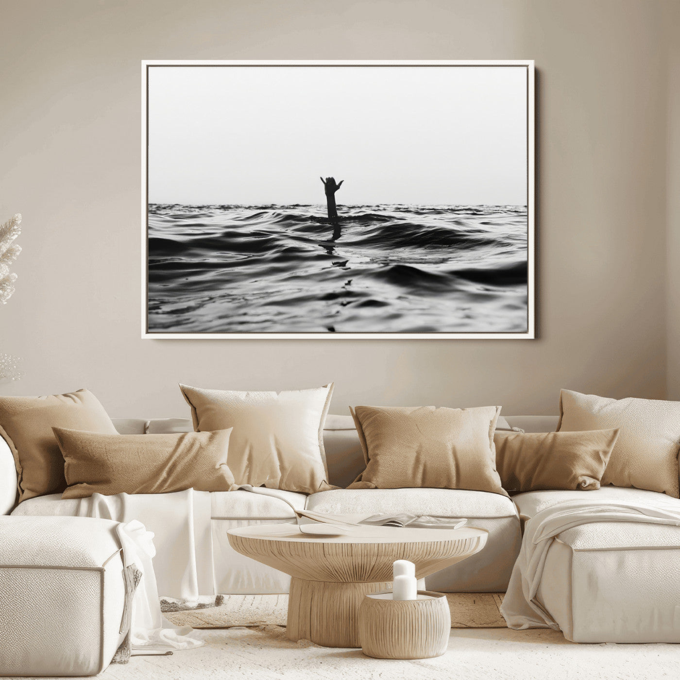 Black and white ocean with a hand making a surfer sign among dark waves, creating a dramatic and minimalist seascape with bold contrast.