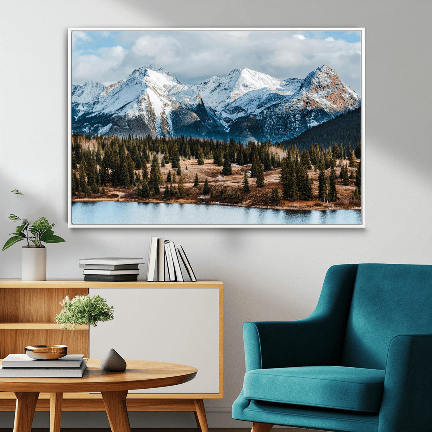 Framed canvas of snowy mountain peaks with pine forest and alpine lake, perfect for winter cabin or wilderness-inspired home decor.