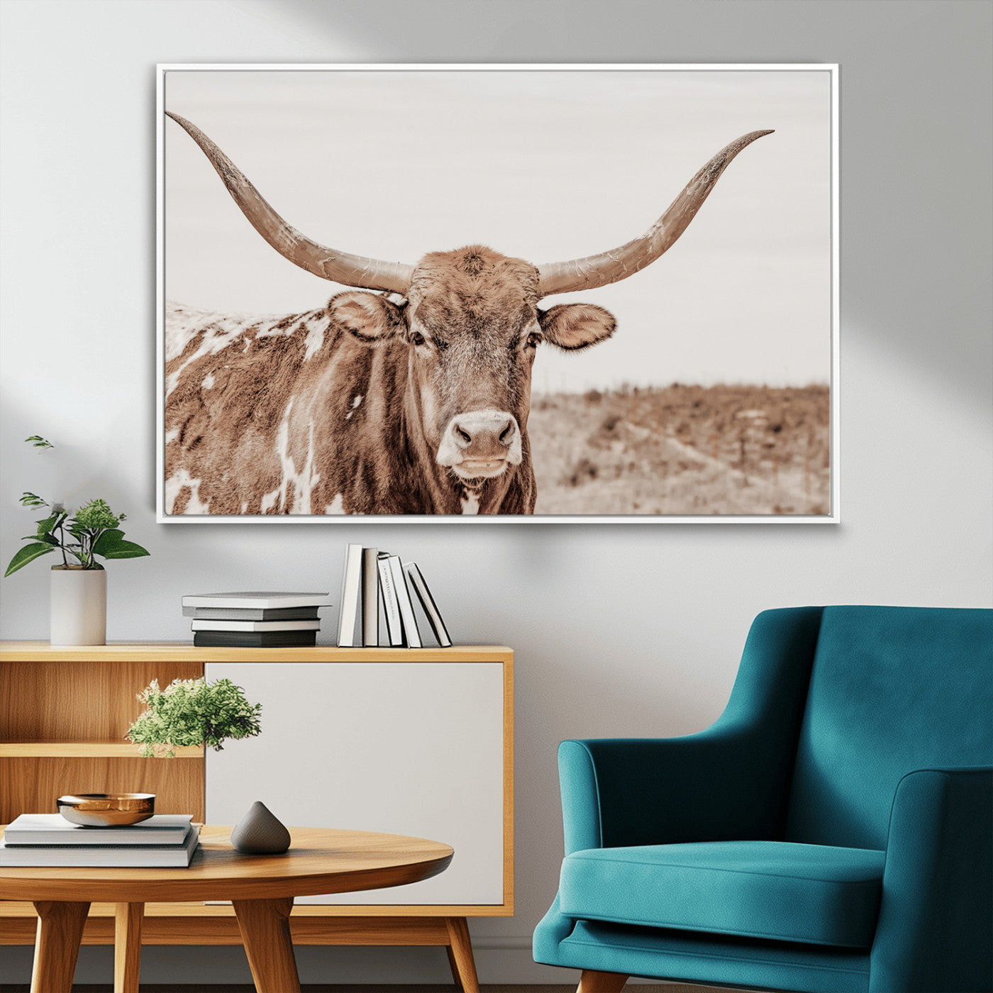 A longhorn cow in soft beige desert tones, standing calmly in open land, perfect for neutral western or rustic farmhouse interiors.